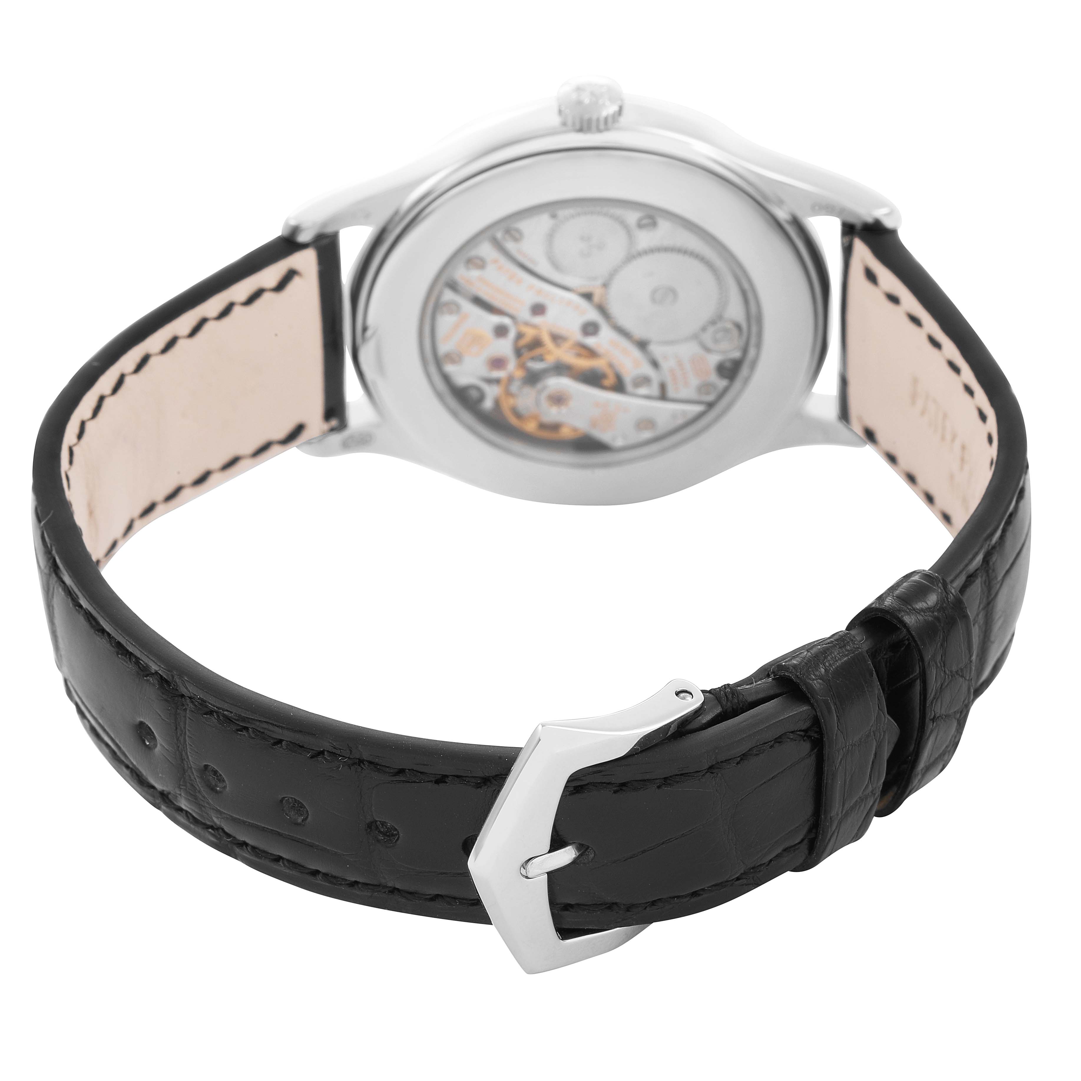 The image shows the back of a Patek Philippe Calatrava 4897G Women's White Gold Blue Dial watch, highlighting the movement and black leather strap with buckle.