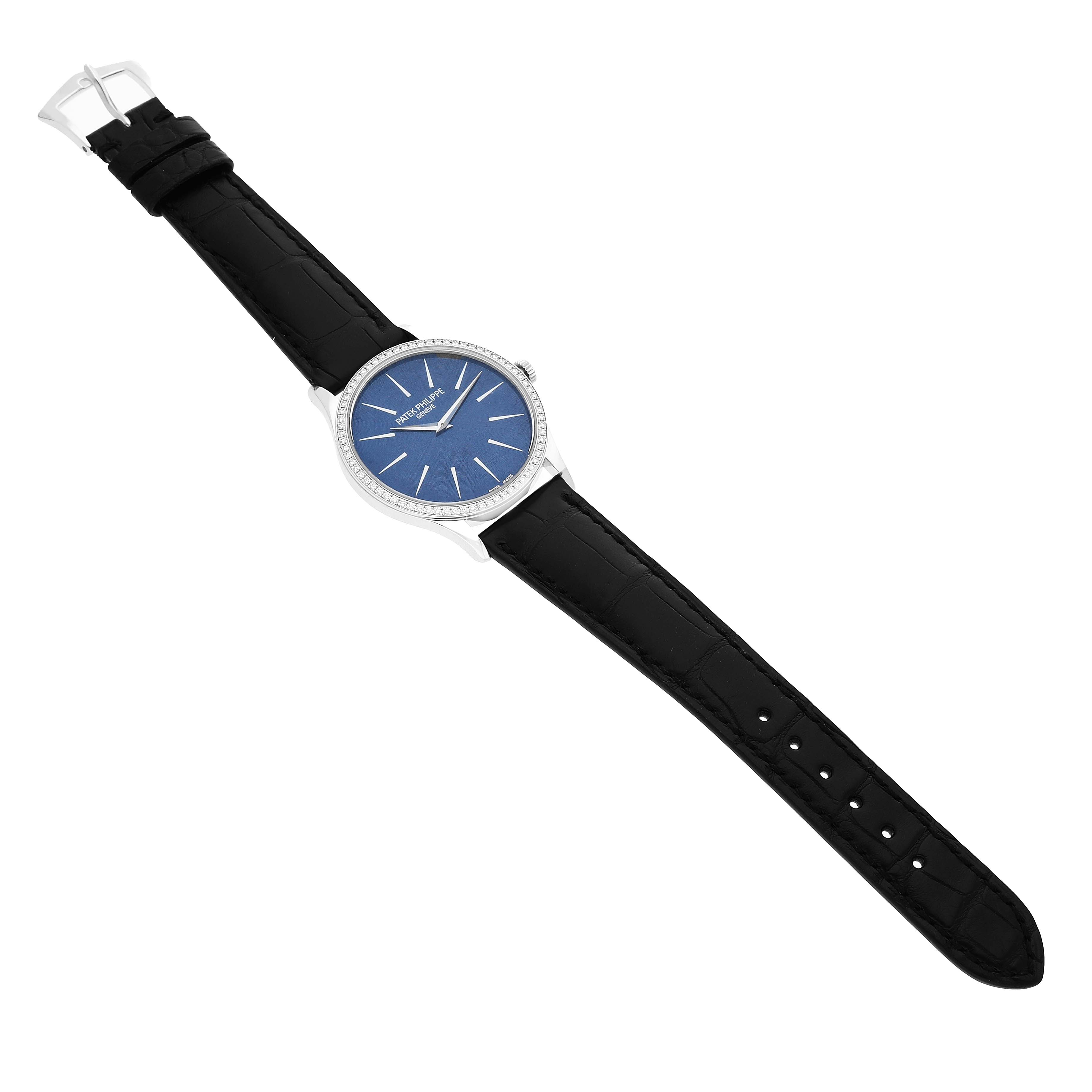 The Patek Philippe Calatrava 4897G Women's White Gold Blue Dial watch is shown at a top-down angle, displaying its face, bezel, and full strap.
