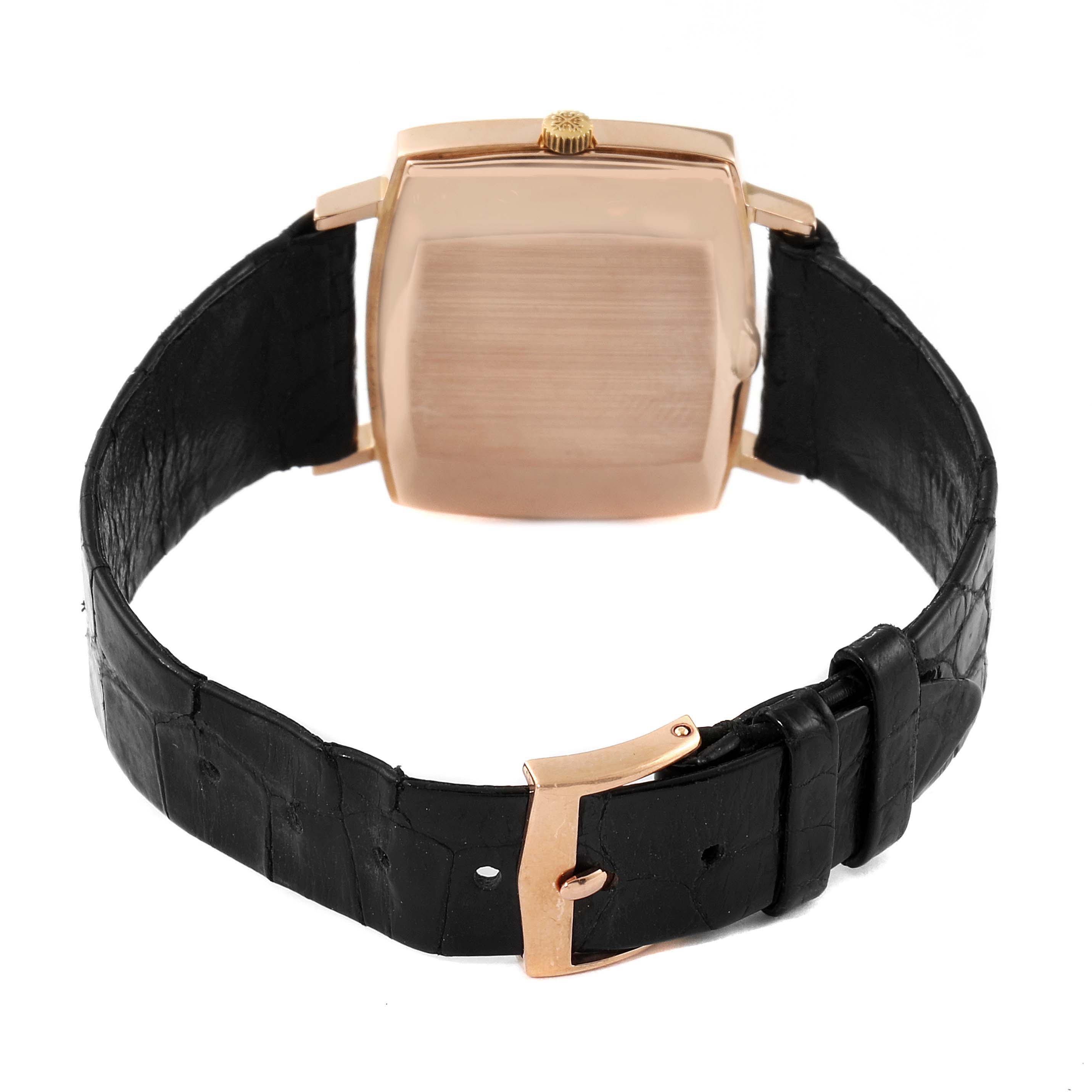 The image shows the back view of a Vintage Patek Philippe watch, highlighting its square case, black leather strap, and clasp.