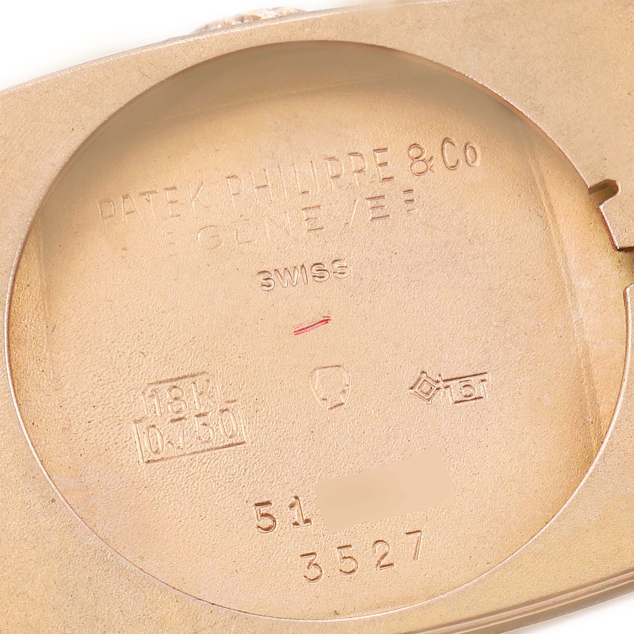 The image shows the inner case back of a vintage Patek Philippe watch, with model engravings and hallmarks visible.