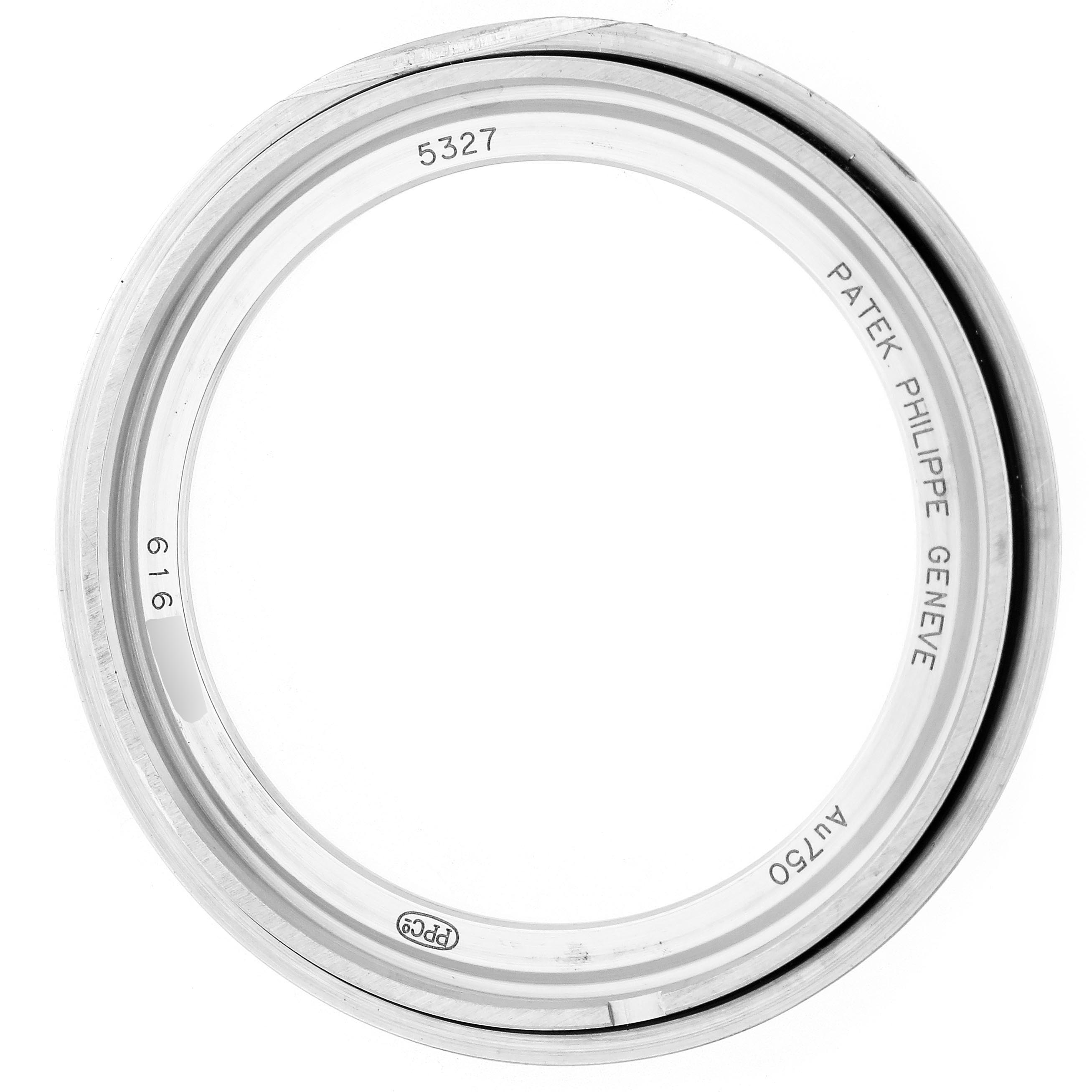 The image shows the bezel of a Patek Philippe Complications 5327G-001 Men's White Gold Blue Dial 5327G-001 Men's White Gold Blue Dial model, viewed from above, displaying engravings and hallmarks.