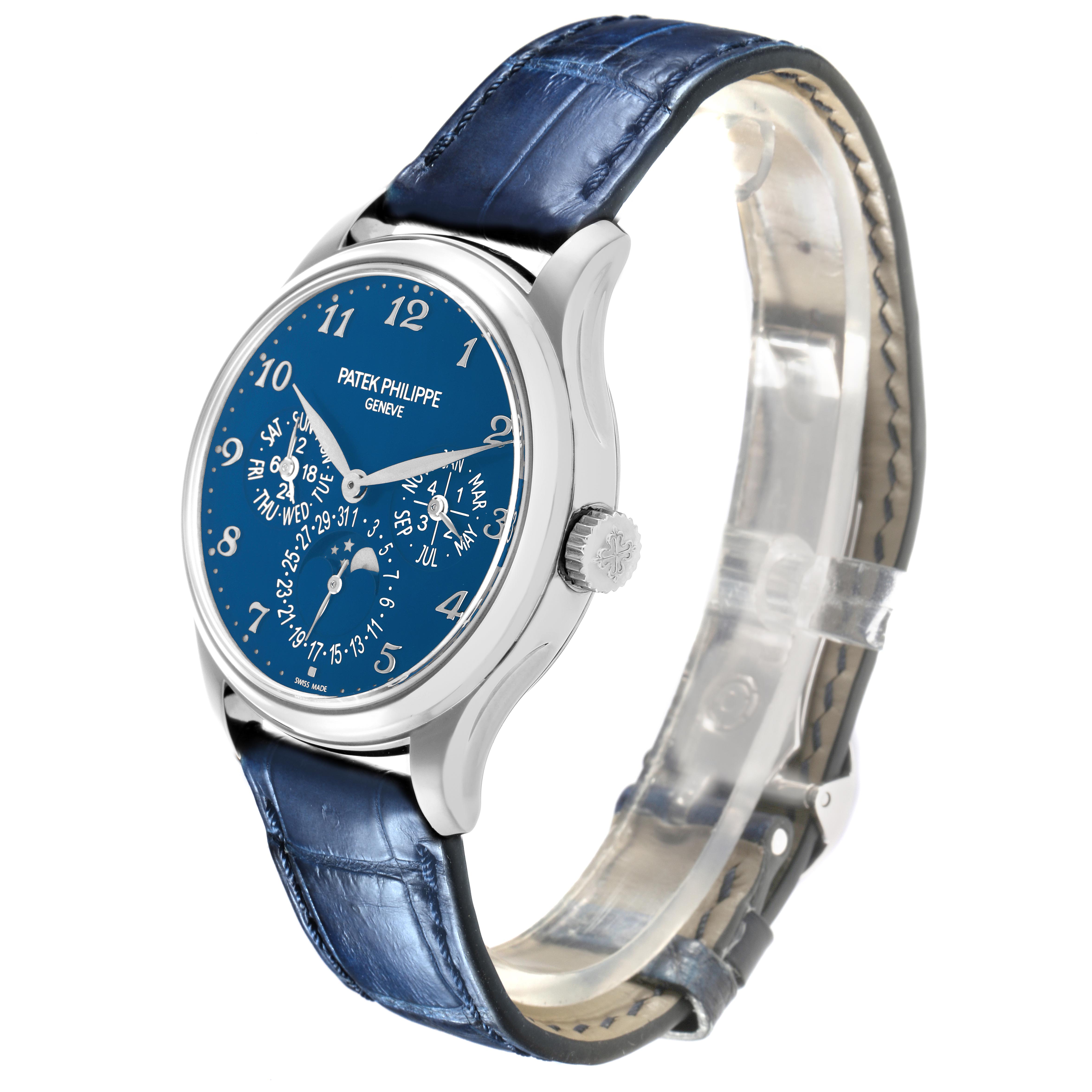 The Patek Philippe Complications 5327G-001 Men's White Gold Blue Dial watch is shown at a slight side angle, displaying the face, crown, and leather strap.
