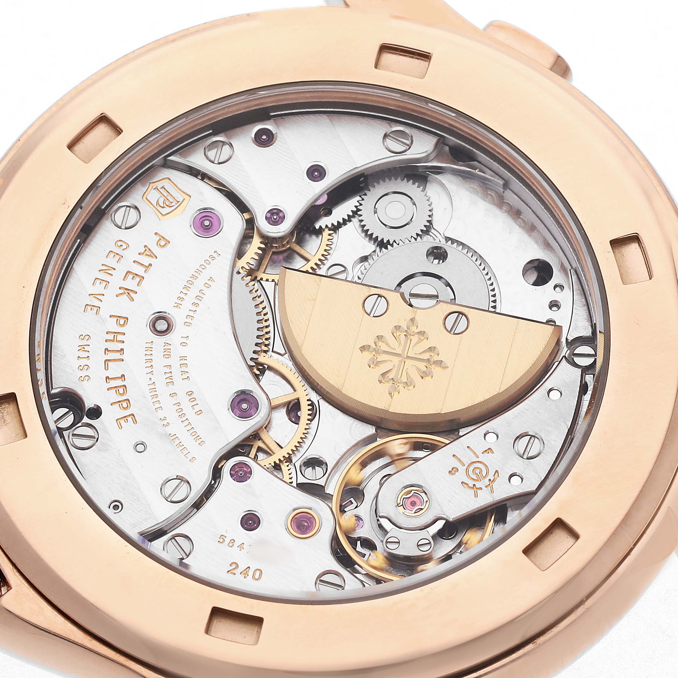 The image shows the back side of a Patek Philippe Complications 5130R Men's Rose Gold Silver Dial watch, revealing its intricate mechanical movement and rotor.