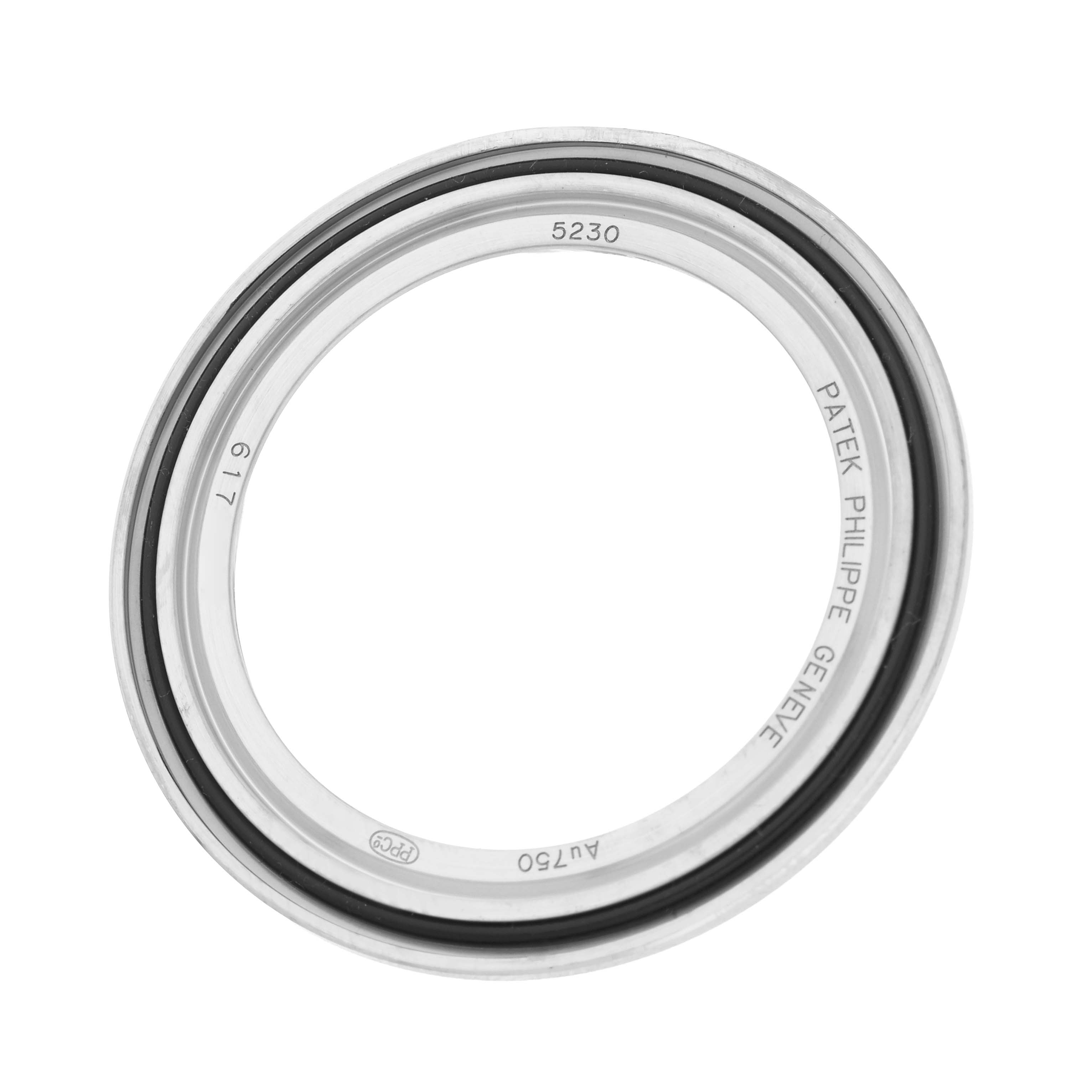 The image shows the bezel of the Patek Philippe Complications 5230G Men's White Gold Grey Dial model from a top view, displaying its engravings.