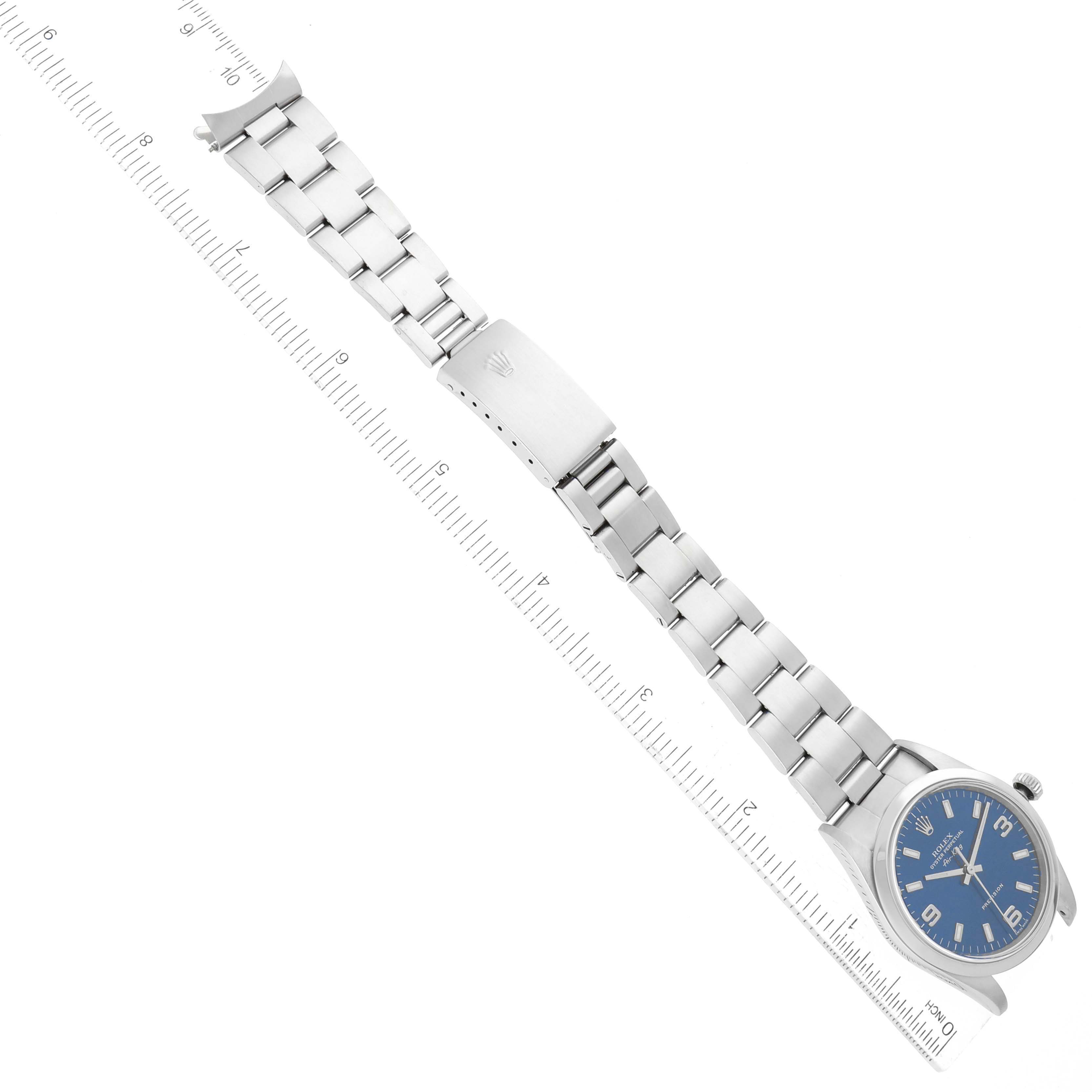 The image shows the Rolex Air-King 14000 Men's Stainless Steel Blue Dial 14000 Men's Stainless Steel Blue Dial watch laid flat with its bracelet extended and placed next to a ruler for scale.