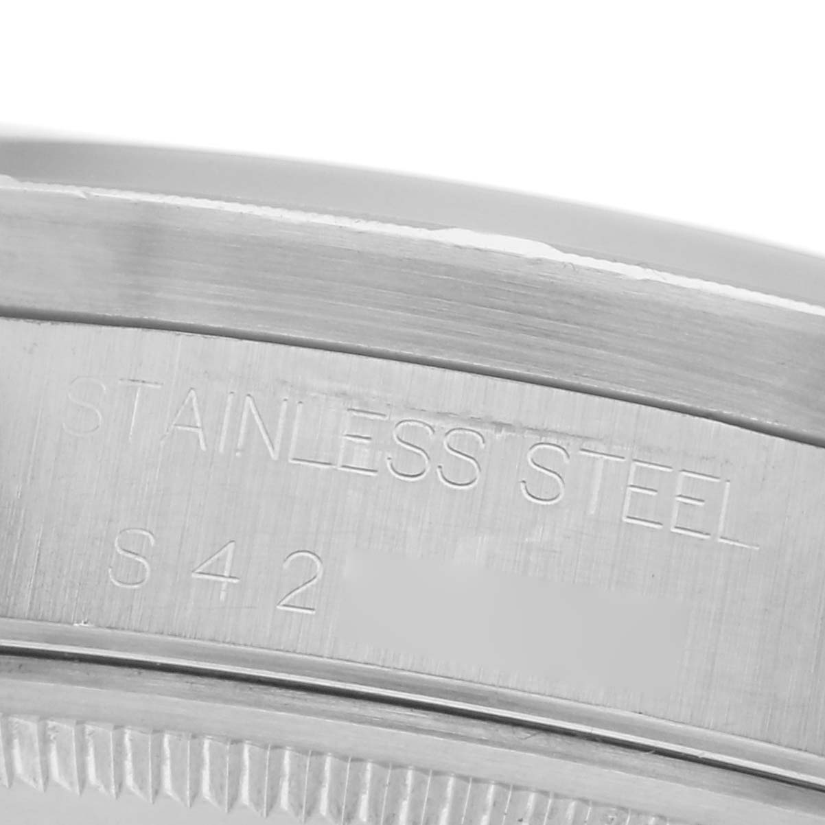 The image shows a close-up of the side engraving on the stainless steel case of a Rolex Air-King 14010 Men's Stainless Steel Black Dial 14010 Men's Stainless Steel Black Dial watch.