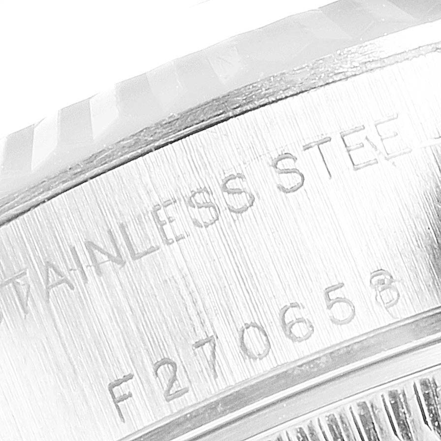 This close-up image shows the stainless steel engraving and serial number on the side of a Rolex Datejust 79174 Women's Stainless Steel Black Dial 79174 Women's Stainless Steel Black Dial watch case.