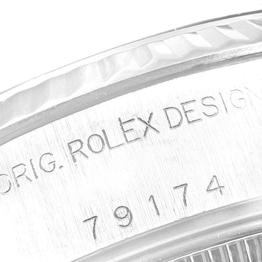 This image shows a close-up of the side of a Rolex Datejust 79174 Women's Stainless Steel Black Dial 79174 Women's Stainless Steel Black Dial watch case, displaying the brand name and model number.