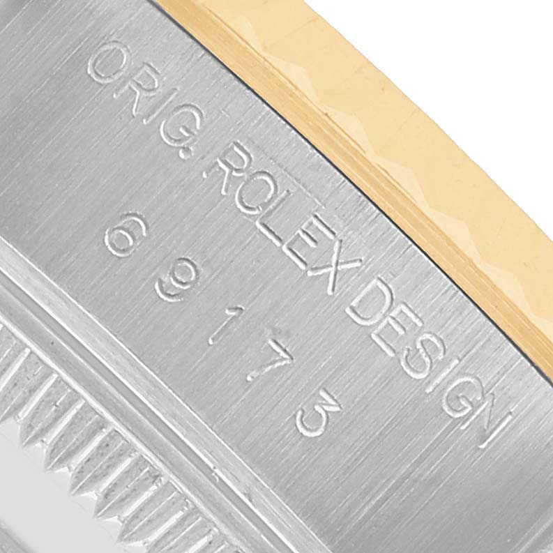 The image shows a close-up side view of the Rolex Datejust 69173 Women's Steel and Gold (two tone) Champagne Dial, highlighting the engraved model details on the case.