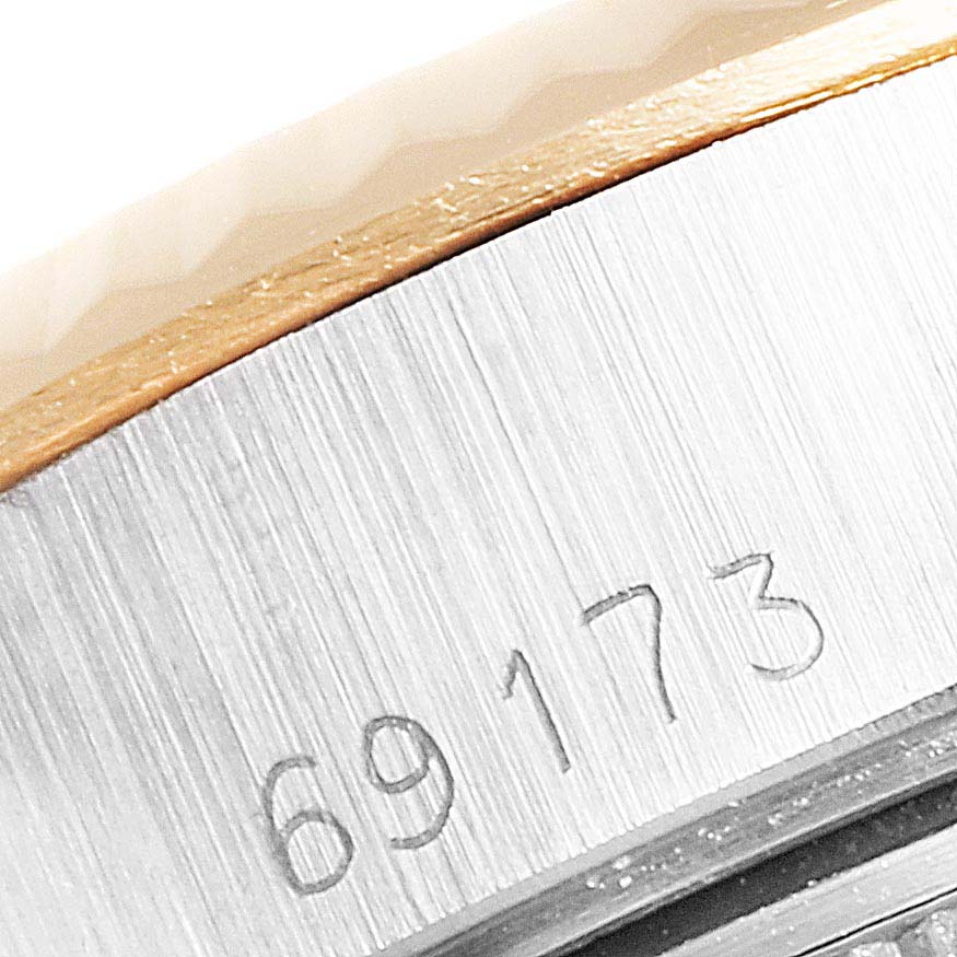 This close-up image shows the serial number engraving on the side of a Rolex Datejust 69173 Women
s Steel and Gold (two tone) Champagne Dial 69173 Women
s Steel and Gold (two tone) Champagne Dial watch case.