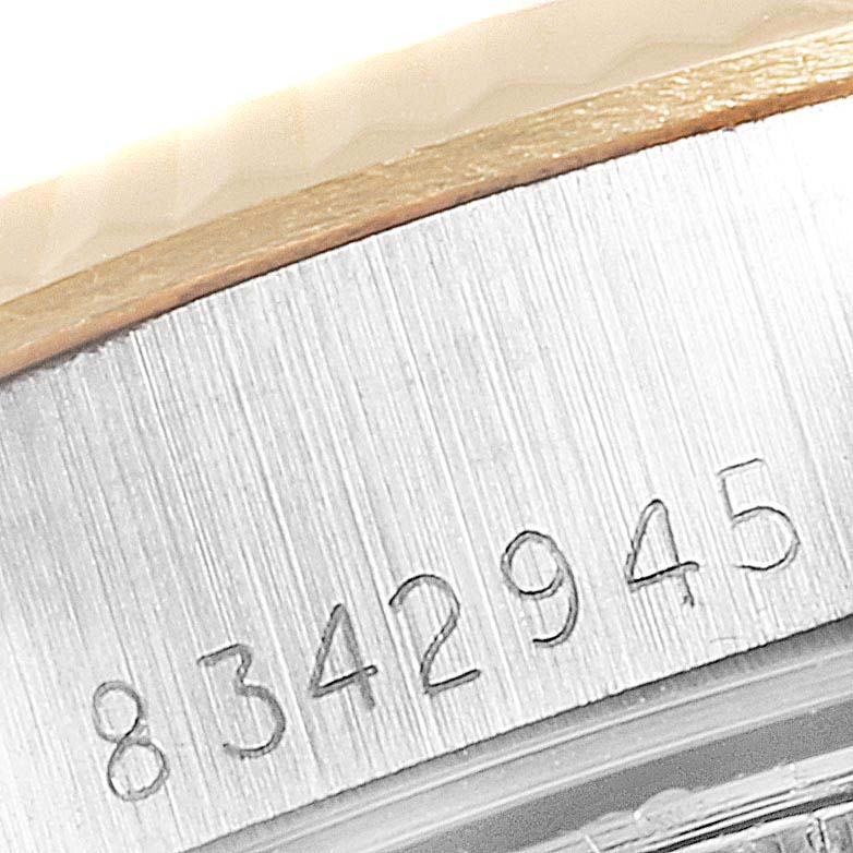 The image shows a close-up of the serial number engraving on the case of a Rolex Datejust 69173 Women
s Steel and Gold (two tone) Champagne Dial 69173 Women
s Steel and Gold (two tone) Champagne Dial watch.