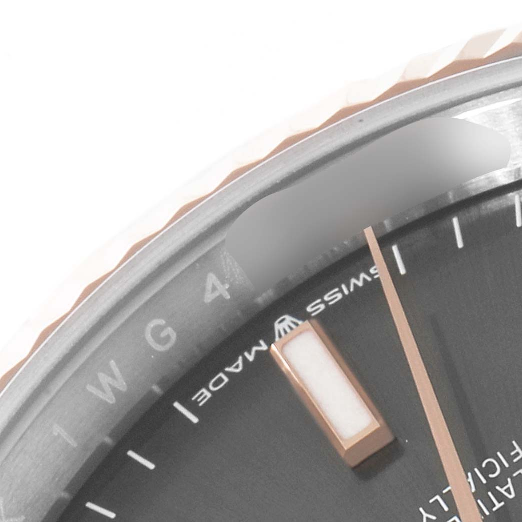 The image shows a close-up, angled view of a Rolex Datejust 126231 Men
s Steel and Gold (two tone) Grey Dial 126231 Men
s Steel and Gold (two tone) Grey Dial watch face, highlighting the "Swiss Made" text and part of the bezel.