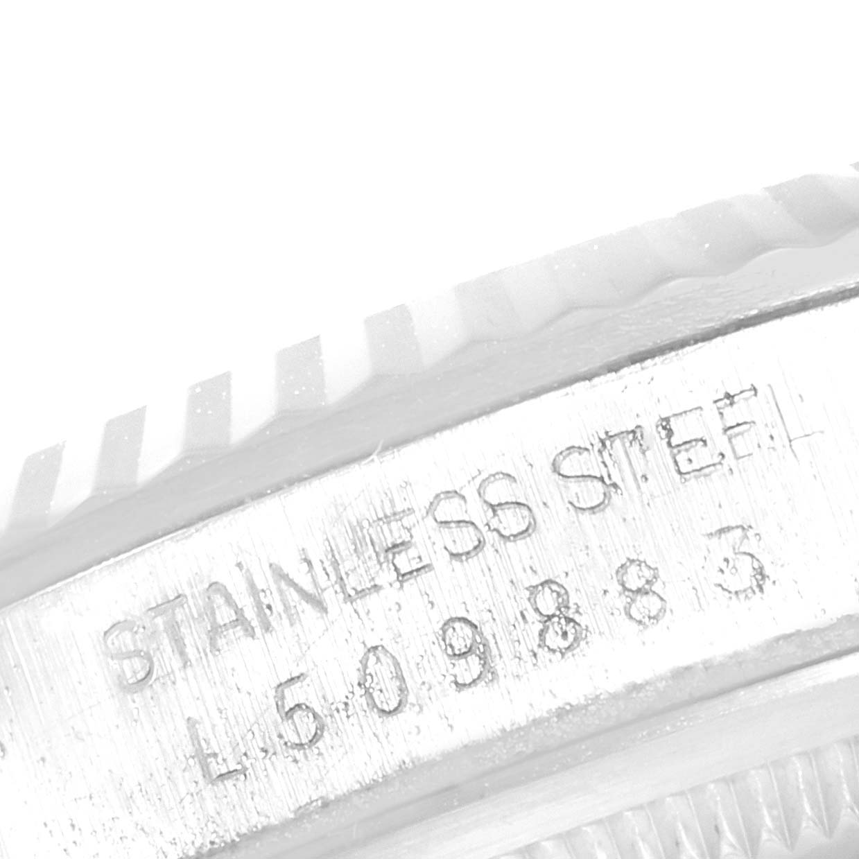 The image shows a close-up of the engraved stainless steel lettering and serial number on a Rolex Datejust 16234 Men's Stainless Steel Silver Dial 16234 Men's Stainless Steel Silver Dial watch bezel.