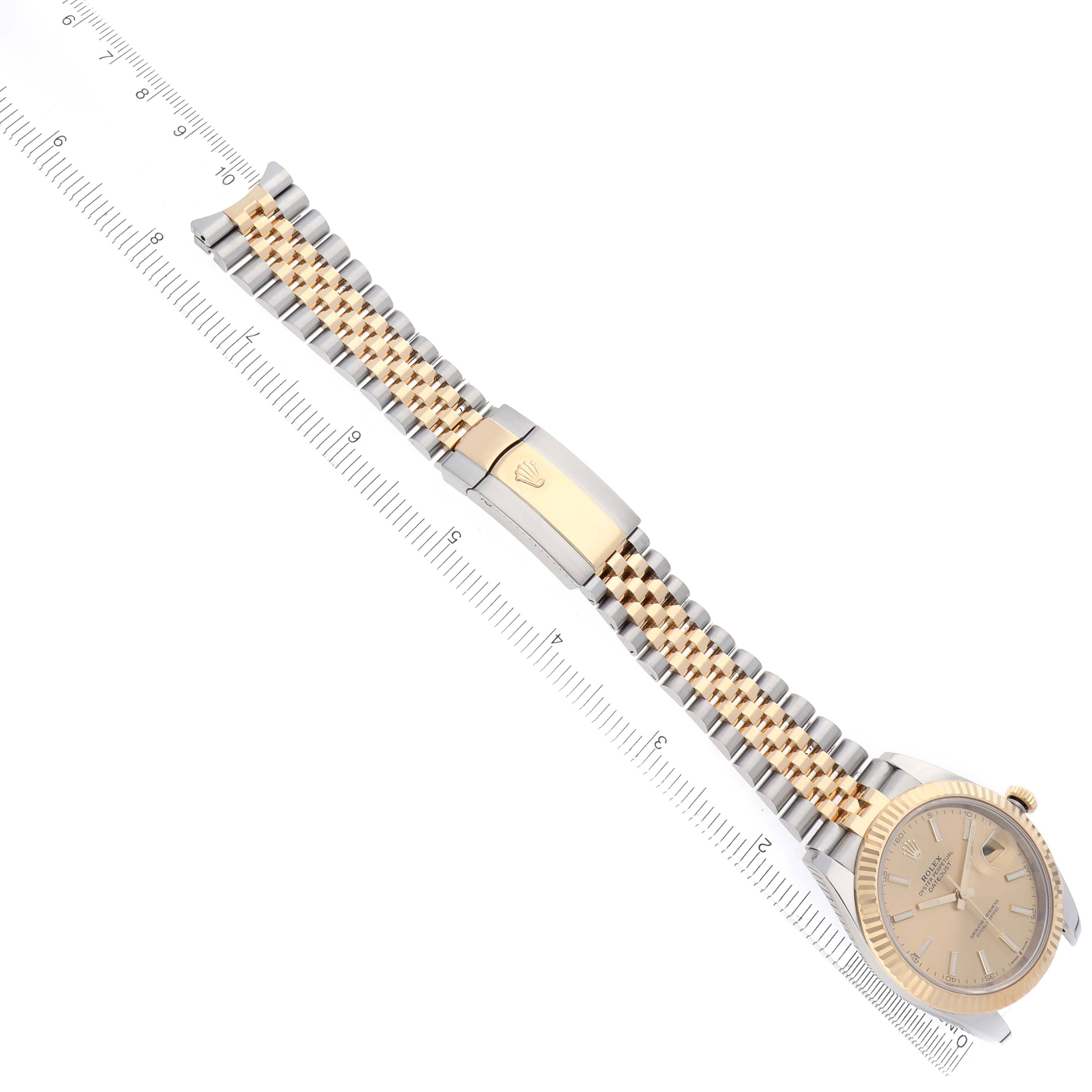 The Rolex Datejust 41 126333 Men's Steel and Gold (two tone) Champagne Dial 126333 Men's Steel and Gold (two tone) Champagne Dial is shown from a diagonal angle, displaying the watch face, bezel, and jubilee bracelet alongside a ruler.