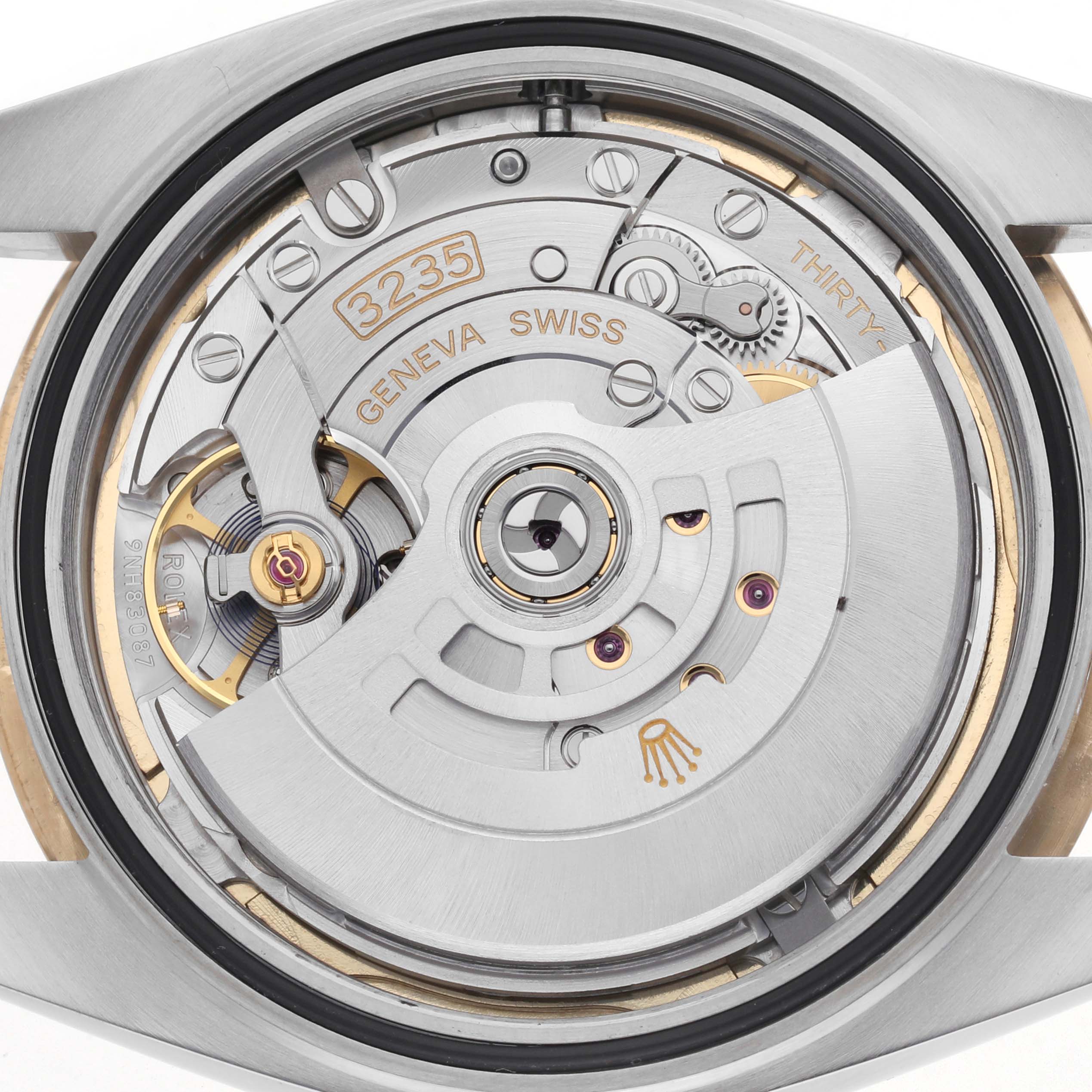 The image shows a close-up of the Rolex Datejust 41 126333 Men's Steel and Gold (two tone) Champagne Dial 126333 Men's Steel and Gold (two tone) Champagne Dial movement, highlighting the rotor and intricate internal components.