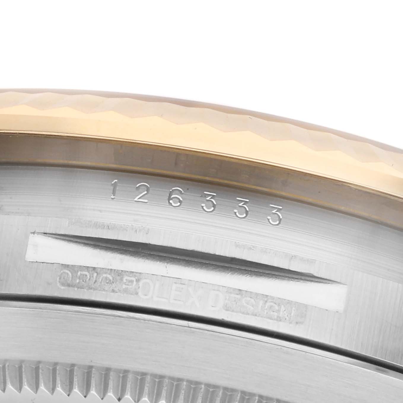 The image shows a close-up of the Rolex Datejust 41 126333 Men's Steel and Gold (two tone) Champagne Dial 126333 Men's Steel and Gold (two tone) Champagne Dial model's case edge, featuring the model number and Rolex design engraving.