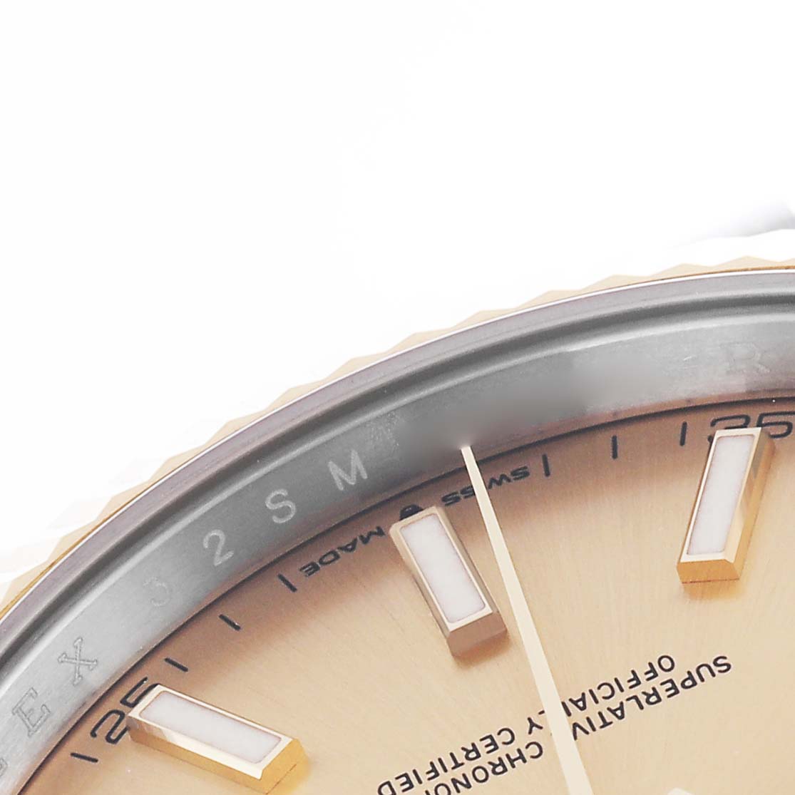 This close-up of the Rolex Datejust 41 126333 Men's Steel and Gold (two tone) Champagne Dial 126333 Men's Steel and Gold (two tone) Champagne Dial shows part of the dial, hour markers, and bezel edge.
