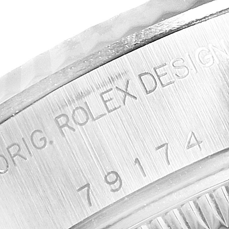 The image shows a close-up of the side engraving on a Rolex Datejust 79174 Women
s Stainless Steel Black Dial 79174 Women
s Stainless Steel Black Dial watch, including the model number "79174."