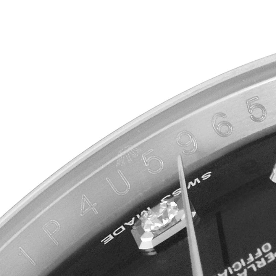 The image shows a close-up view of the serial number engraving and part of the dial of the Rolex Datejust 116234 Men's Stainless Steel Black Dial 116234 Men's Stainless Steel Black Dial watch.