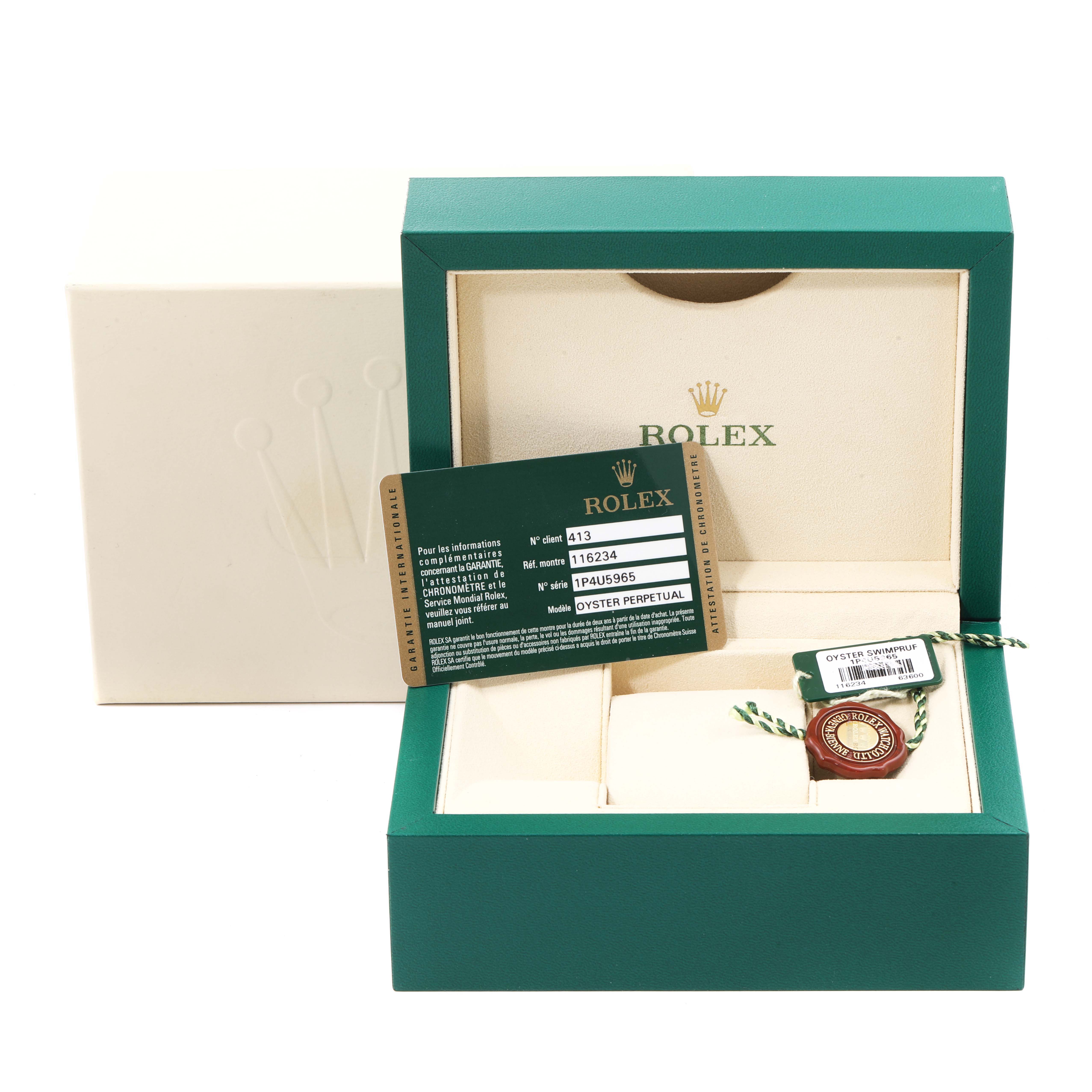 The image shows an open Rolex Datejust 116234 Men's Stainless Steel Black Dial 116234 Men's Stainless Steel Black Dial box with a green card, warranty booklet, and hang tag placed inside.