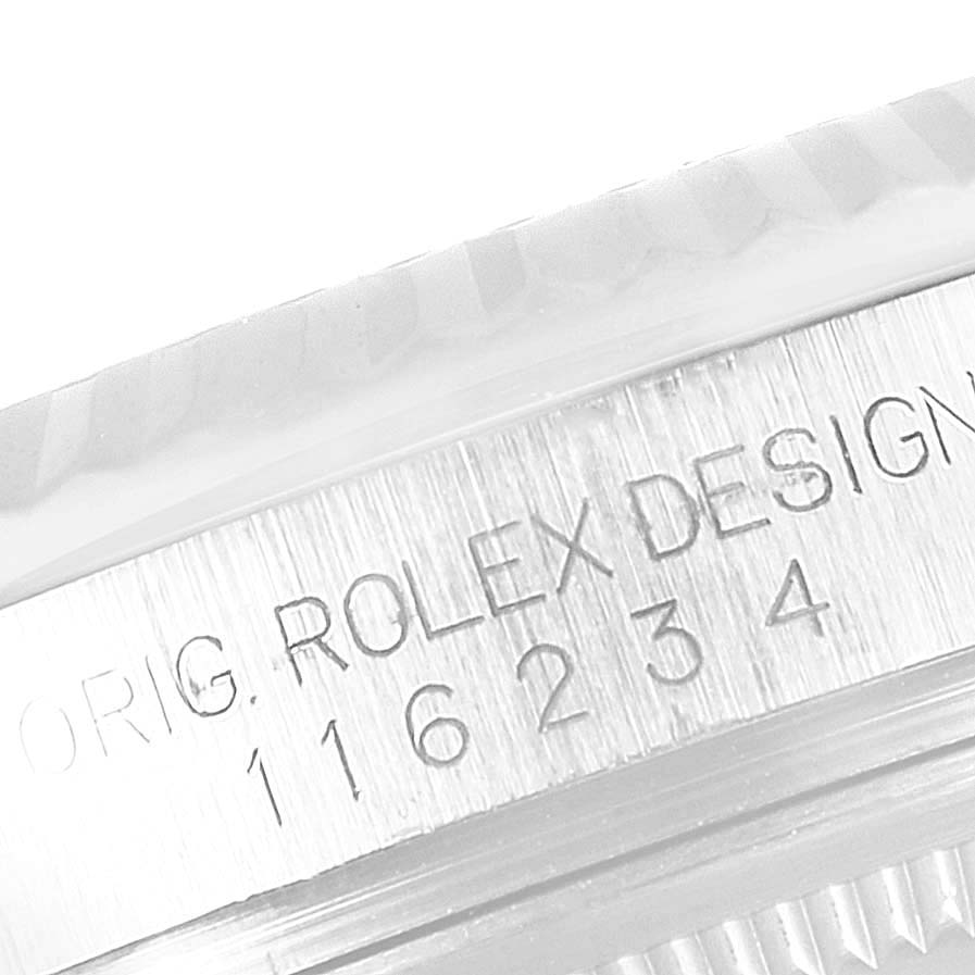 The image shows a close-up of the engraved side of the case of a Rolex Datejust 116234 Men's Stainless Steel Black Dial 116234 Men's Stainless Steel Black Dial watch, revealing its design details and model number.