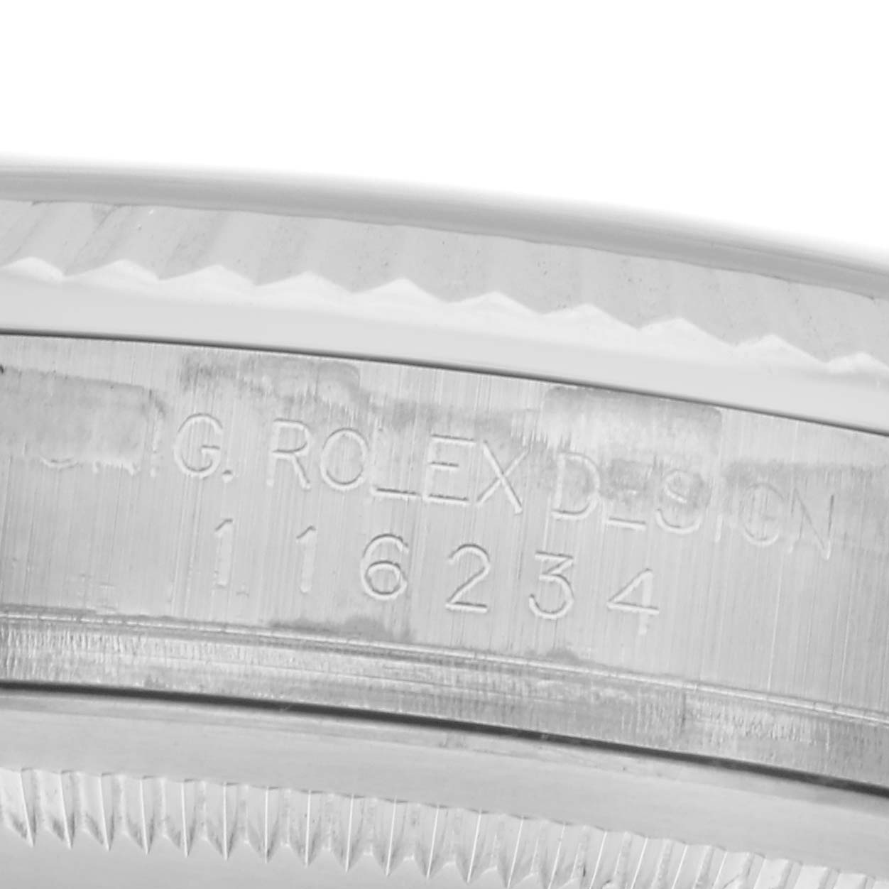 The image shows a close-up of the side of a Rolex Datejust 116234 Men's Stainless Steel Silver Dial 116234 Men's Stainless Steel Silver Dial watch, highlighting the engraved design and model number.