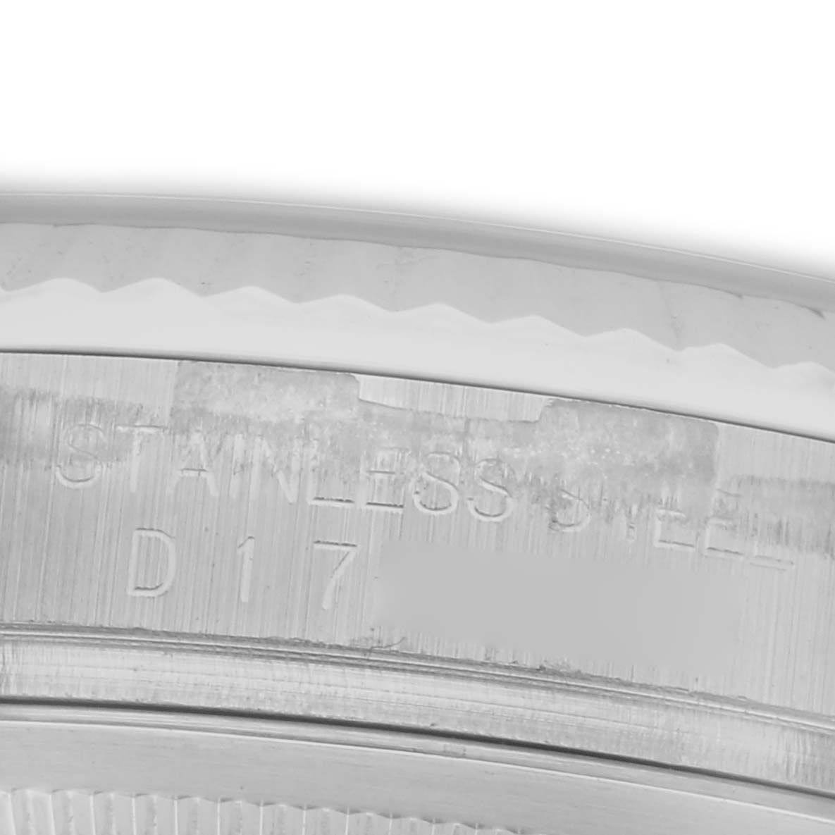 The image shows a close-up of the engravings on the stainless steel case of a Rolex Datejust 116234 Men's Stainless Steel Silver Dial 116234 Men's Stainless Steel Silver Dial watch.