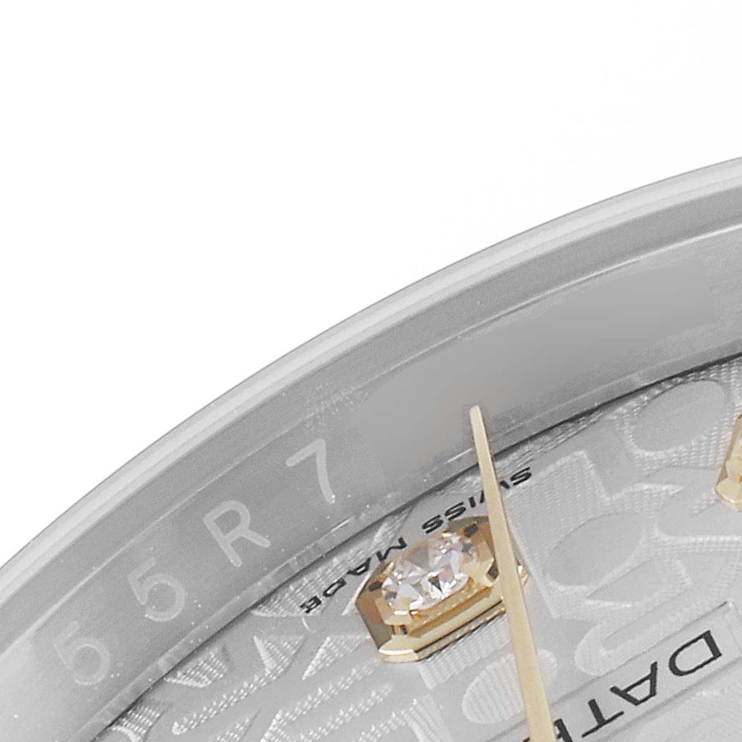 This close-up image of a Rolex Datejust 116233 Men's Steel and Gold (two tone) Silver Dial 116233 Men's Steel and Gold (two tone) Silver Dial watch shows the dial, a diamond marker, and part of the hands.