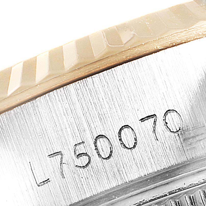 The image shows a zoomed-in view of the serial number engraving on the Rolex Datejust 69173 Women's Steel and Gold (two tone) Champagne Dial 69173 Women's Steel and Gold (two tone) Champagne Dial model's case.