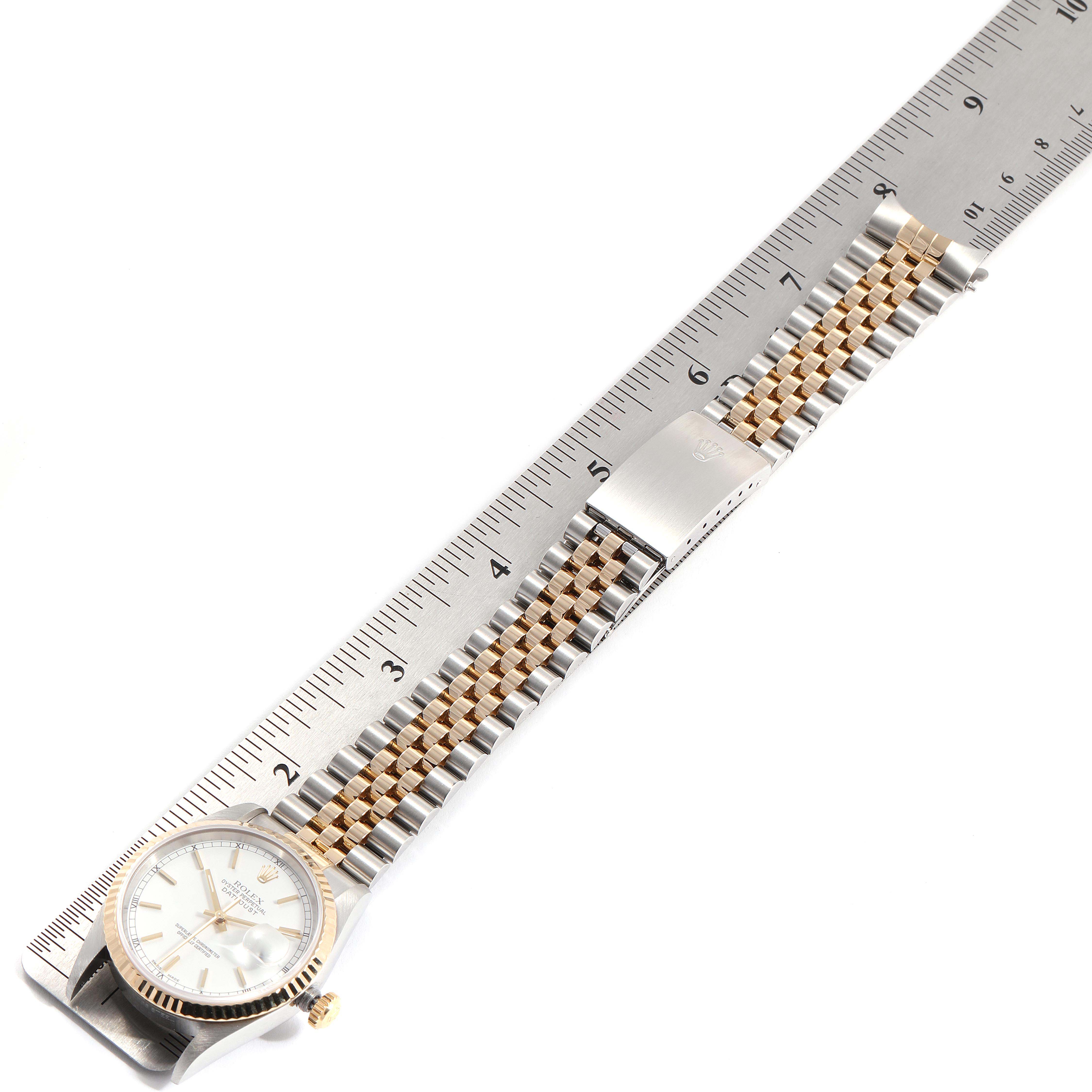 The Rolex Datejust 16233 Men's Stainless Steel White Dial 16233 Men's Stainless Steel White Dial watch is shown fully extended with a metal ruler beside it for scale.