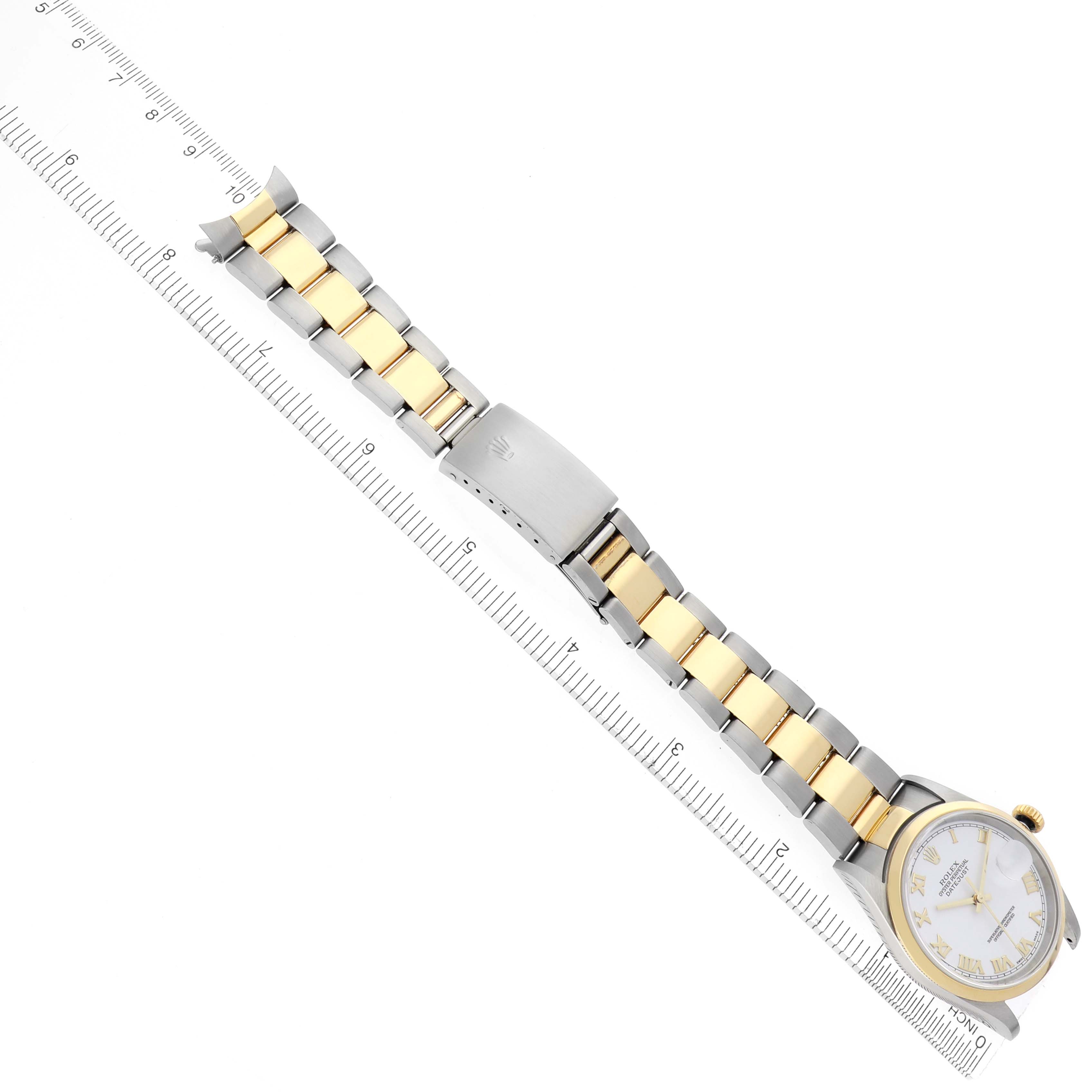 The Rolex Datejust 16203 Men's Steel and Gold (two tone) White Dial 16203 Men's Steel and Gold (two tone) White Dial watch is shown from a top view, displaying the face, bracelet, and clasp alongside a ruler for scale.