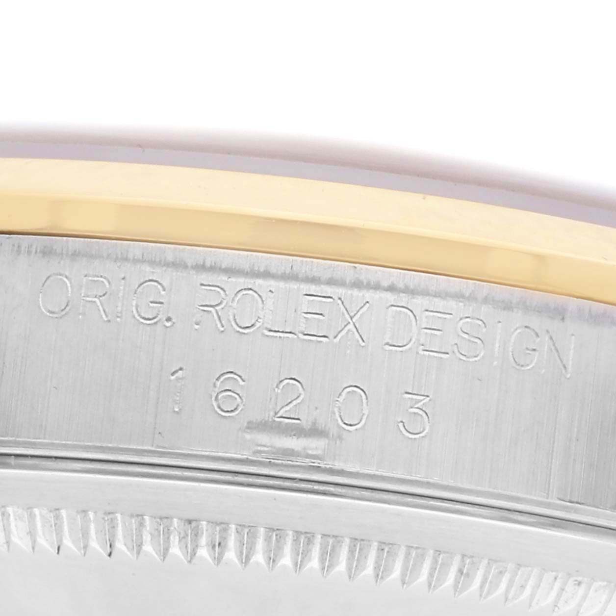 The image shows a close-up of the side of a Rolex Datejust 16203 Men's Steel and Gold (two tone) White Dial 16203 Men's Steel and Gold (two tone) White Dial watch case with engraved model number 16203.
