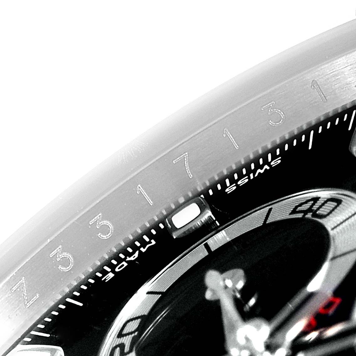 This close-up image shows part of the dial and bezel of a Rolex Daytona 116520 Men's Stainless Steel Black Dial 116520 Men's Stainless Steel Black Dial watch.