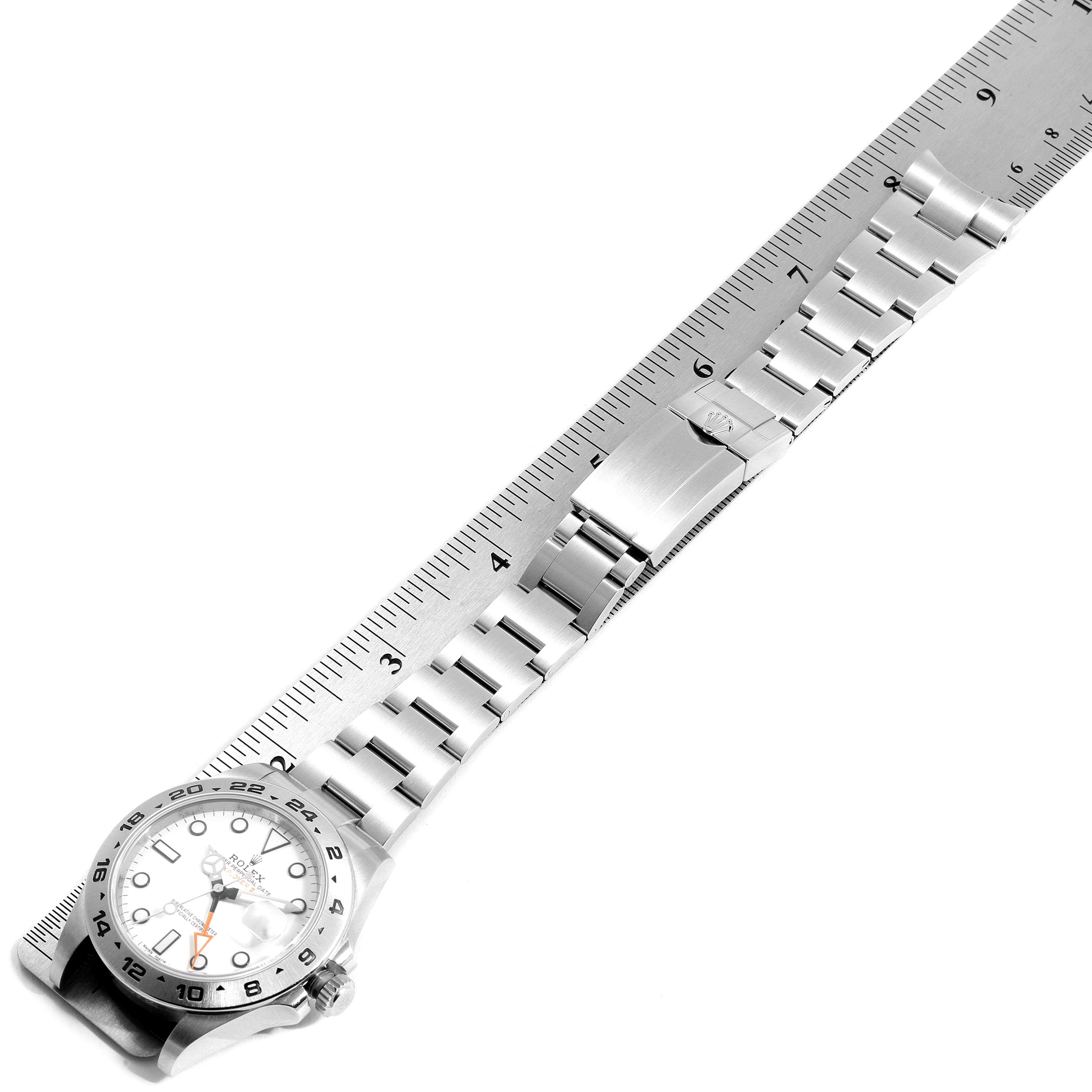The image shows a full view of the Rolex Explorer 216570 Men
s Stainless Steel White Dial 216570 Men
s Stainless Steel White Dial watch, including the face, crown, bezel, and metal bracelet, with a ruler for scale.