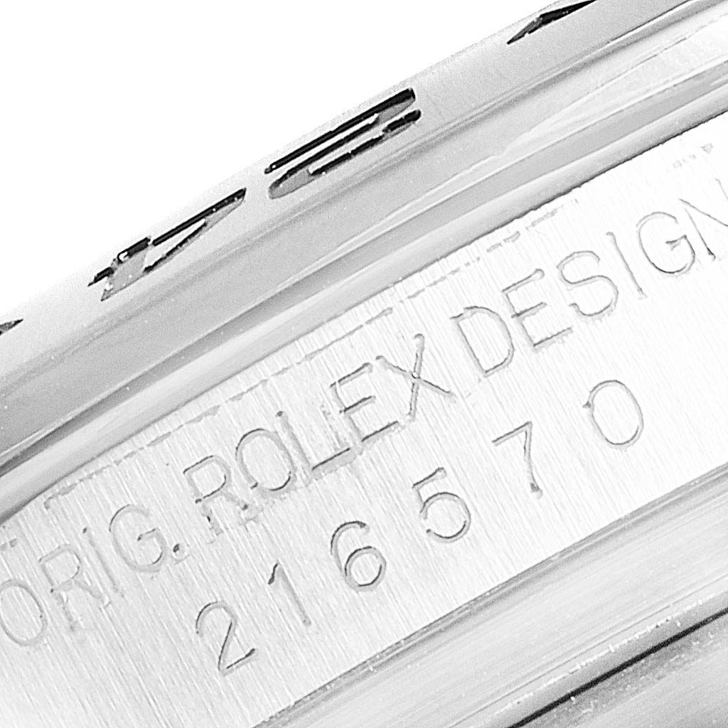 Close-up of the engraved serial number and "ORIG. ROLEX DESIGN" text on the side of the Rolex Explorer 216570 Men
s Stainless Steel White Dial 216570 Men
s Stainless Steel White Dial watch case.