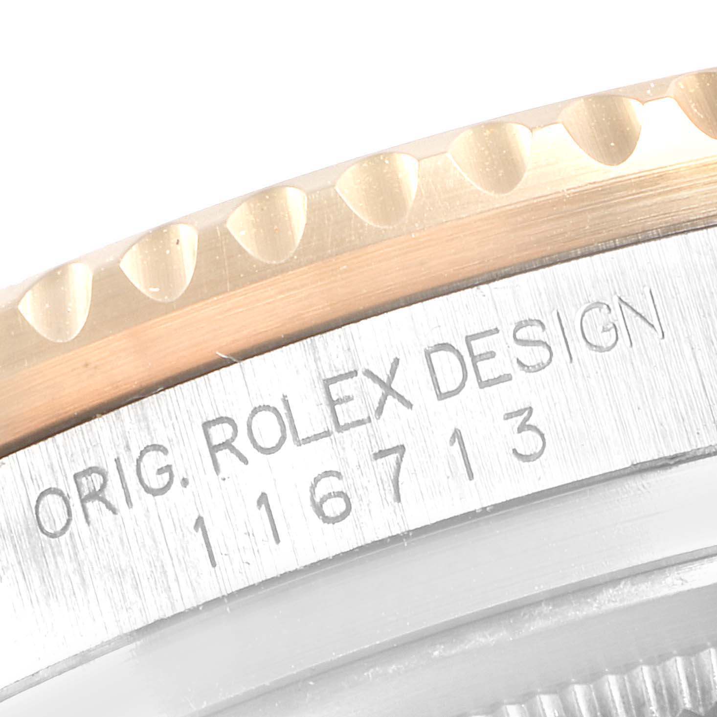 The image shows a close-up of the edge of the bezel and case with the model number of a Rolex GMT-Master 116713 Men's Steel and Gold (two tone) Black Dial 116713 Men's Steel and Gold (two tone) Black Dial.