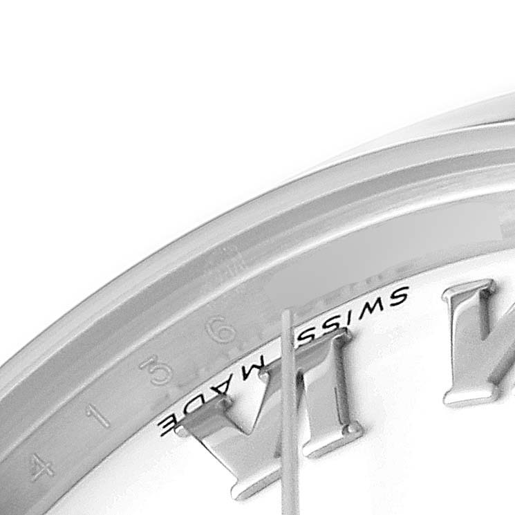 This close-up image shows the "Swiss Made" text and roman numerals of the dial on a Mid-Size Rolex watch.