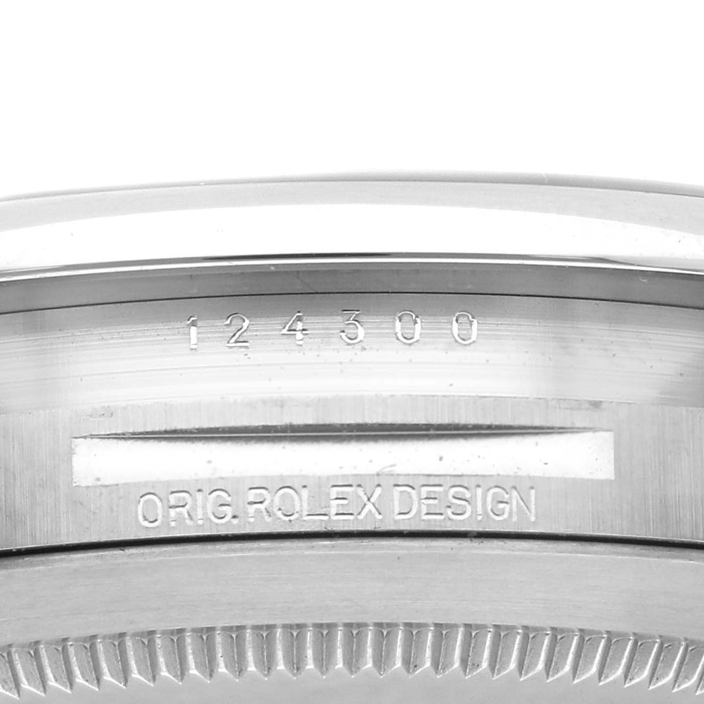 The image shows a close-up of the case engraving and bezel edge of a Rolex Oyster Perpetual 124300 Men's Stainless Steel Black Dial 124300 Men's Stainless Steel Black Dial watch.