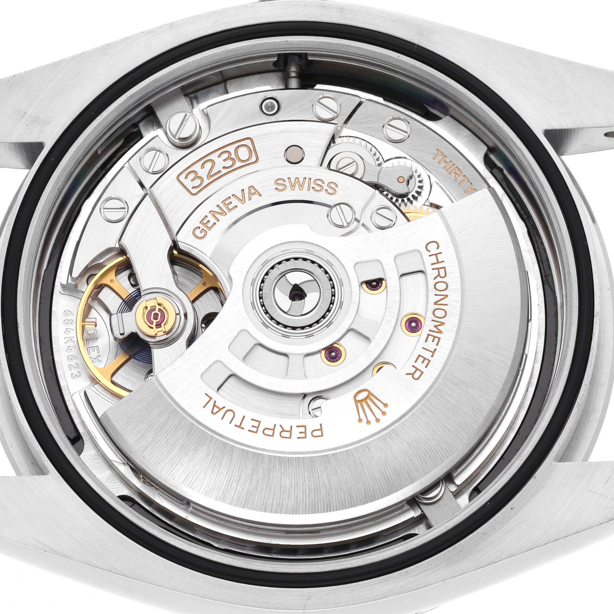 The image shows the movement of a Rolex Oyster Perpetual 124300 Men's Stainless Steel Black Dial 124300 Men's Stainless Steel Black Dial, focusing on the intricate gears and winding mechanism.