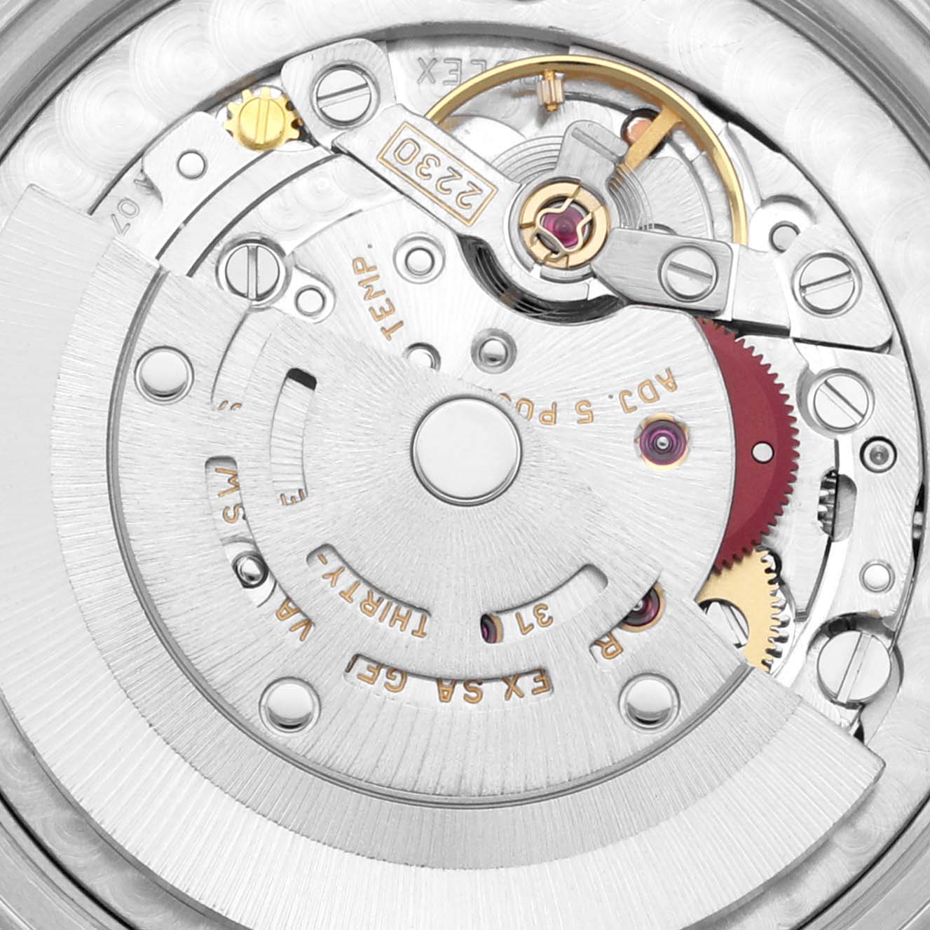 The image shows a close-up of the internal mechanism of a Rolex Mid-Size 77080 Women's Stainless Steel Orange Dial 77080 Women's Stainless Steel Orange Dial model watch, highlighting the gears and movement components.
