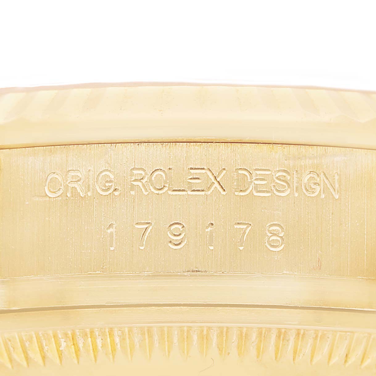 The image shows a close-up of the side engraving on a Rolex President 179178 Women's Yellow Gold White Dial watch case, displaying the model number and "ORIG. ROLEX DESIGN."