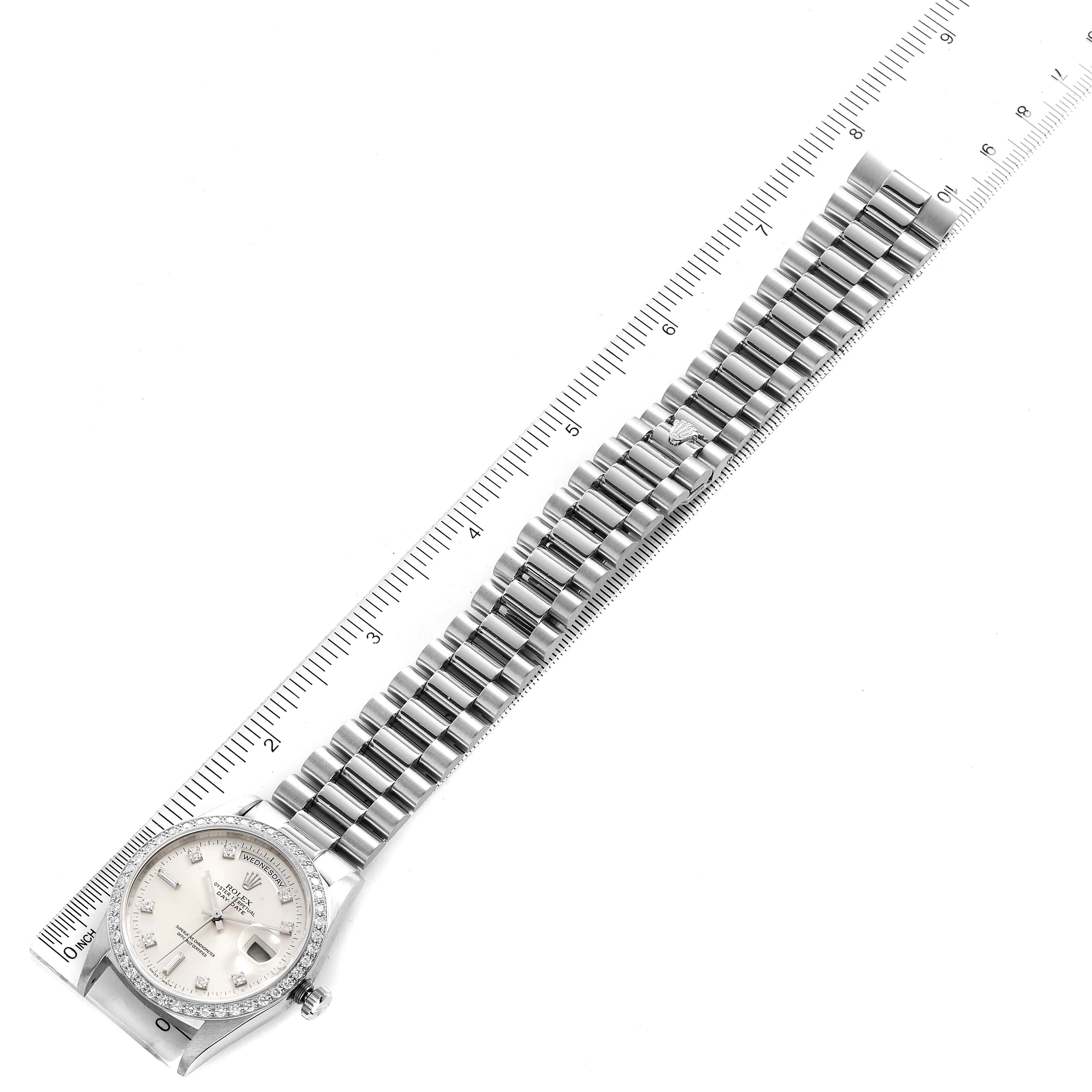 This image shows a Rolex President 18346 Men's Platinum Silver Dial 18346 Men's Platinum Silver Dial model watch laid flat, showcasing its face, bracelet, and part of a ruler for scale.