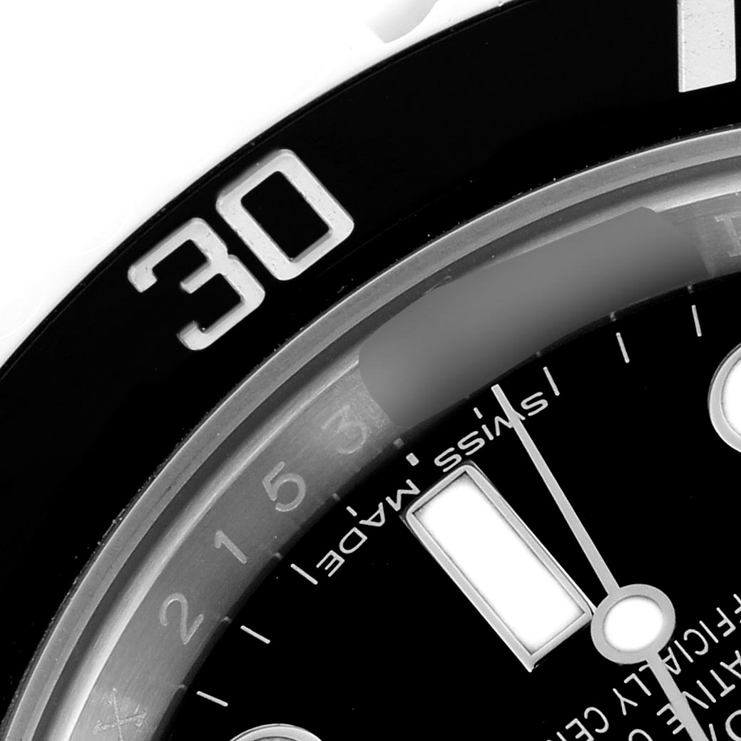 The image shows a close-up of the bezel and dial of a Rolex Submariner 114060 Men's Stainless Steel Black Dial 114060 Men's Stainless Steel Black Dial, highlighting the 30-minute mark and Swiss Made inscription.