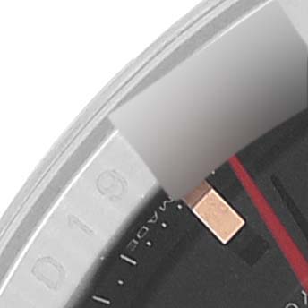 This close-up image shows part of the bezel and the face of a Rolex Turn-o-Graph 116261 Men
s Steel and Gold (two tone) Black Dial 116261 Men
s Steel and Gold (two tone) Black Dial watch, highlighting the marked numbers and a red hand.