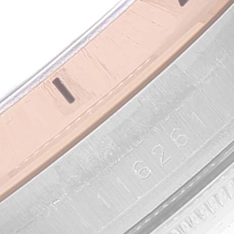 This close-up image of a Rolex Turn-o-Graph 116261 Men
s Steel and Gold (two tone) Black Dial 116261 Men
s Steel and Gold (two tone) Black Dial watch shows part of its bezel and the engraved serial number.