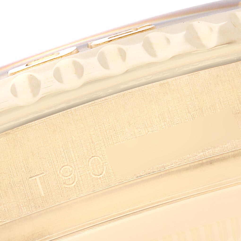 The image shows a close-up of the Rolex Yacht-Master 16628 Men's Yellow Gold Mother of Pearl Dial 16628 Men's Yellow Gold Mother of Pearl Dial's engraved bezel edge and part of the case, viewed from an oblique angle.