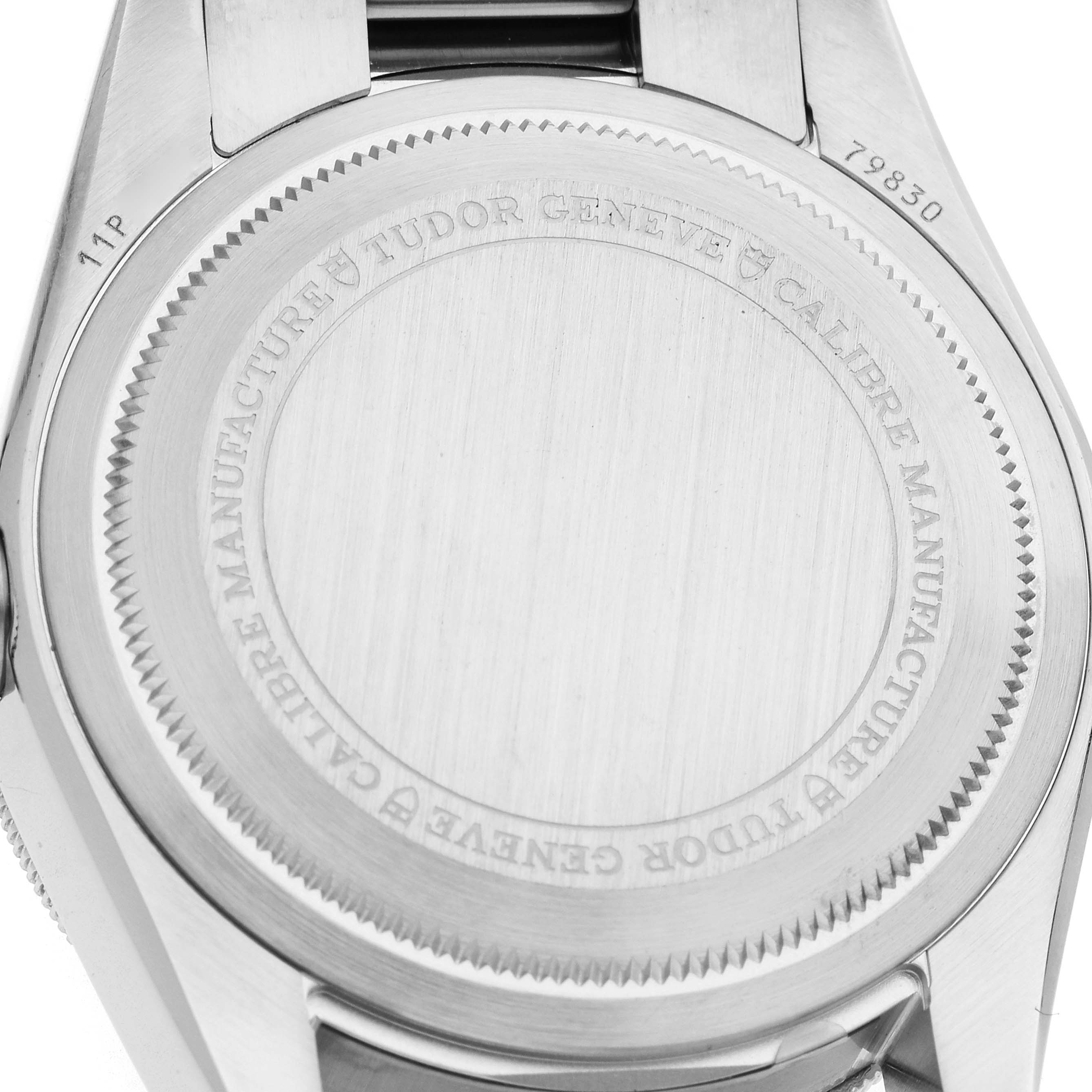 The image shows the back side of a Tudor Heritage Black Bay 79830RB Men's Stainless Steel Black Dial watch, highlighting its polished caseback with engravings.