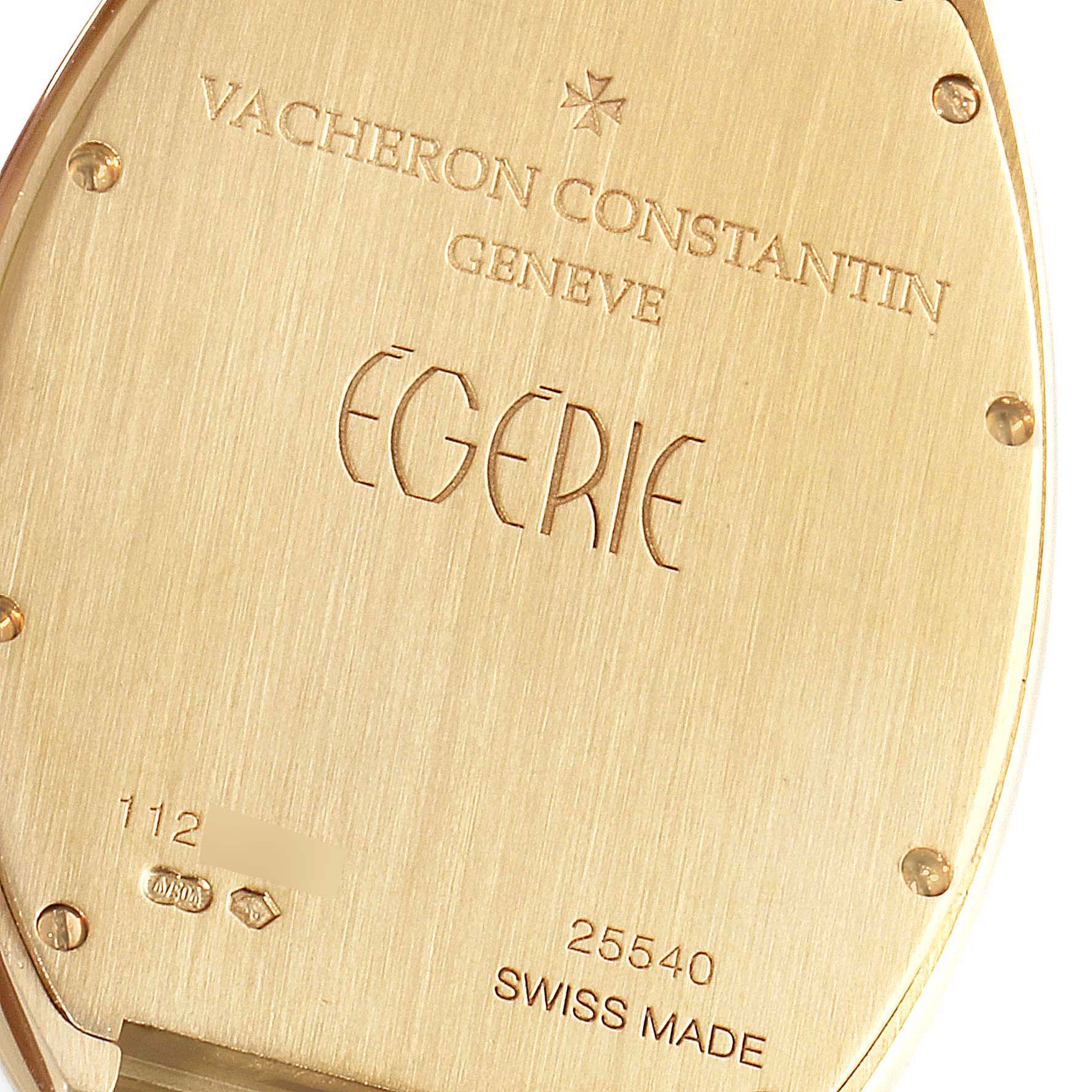 The image shows a close-up of the back case of a Vacheron Constantin Egerie 25540/344J Women
s Rose Gold Silver Dial 25540/344J Women
s Rose Gold Silver Dial watch, displaying engravings and screws.
