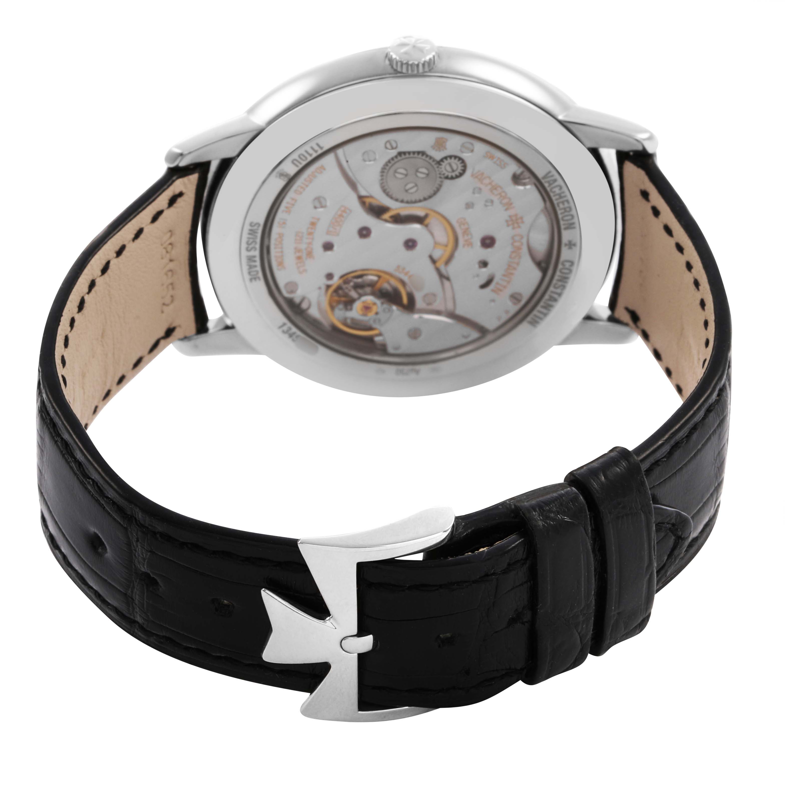 This image shows the back and inner mechanism of the Vacheron Constantin Patrimony 1110U Men's White Gold Silver Dial watch, along with its leather strap and clasp.