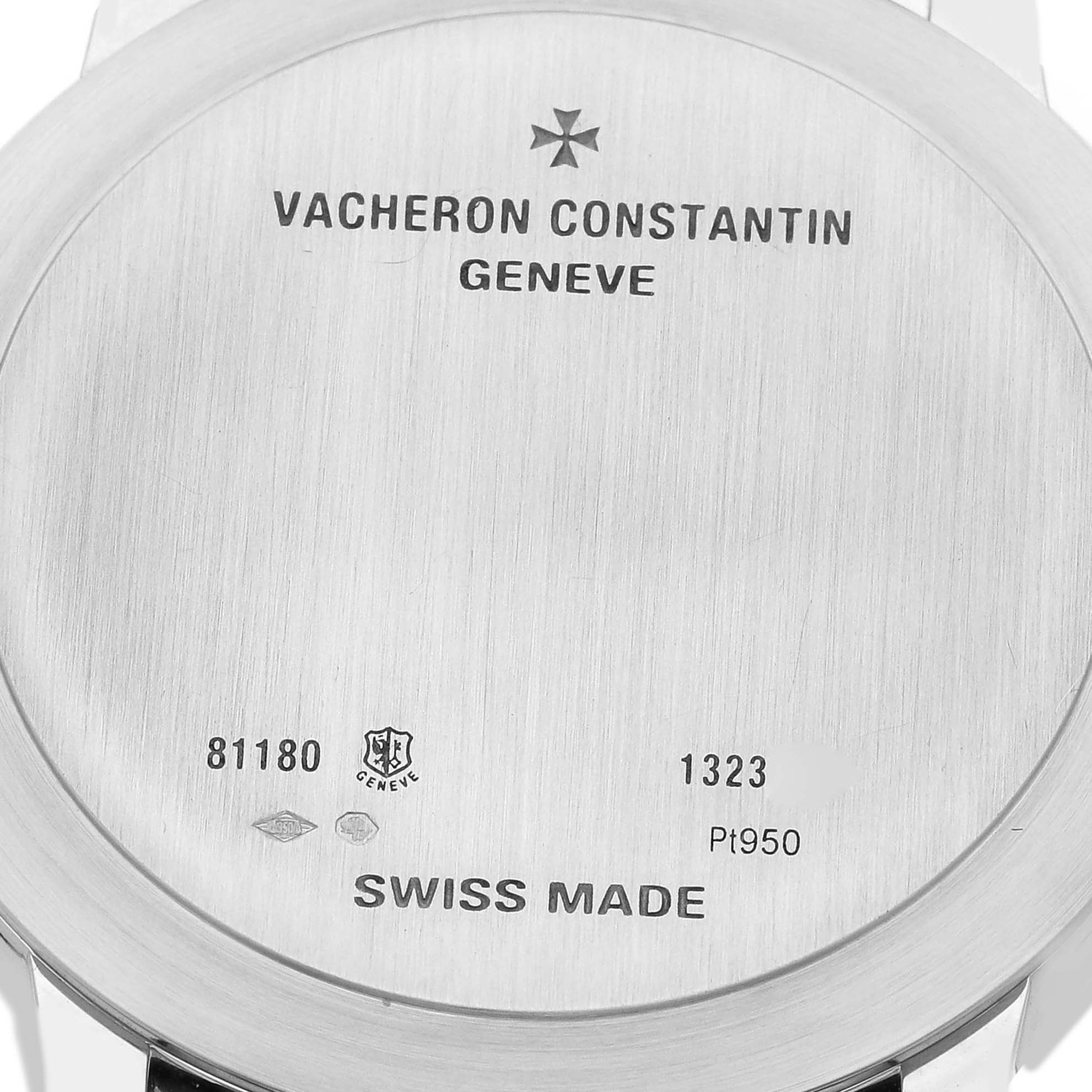 The image shows the back case of a Patrimony model watch by Vacheron Constantin, displaying engravings and Swiss-made markings.